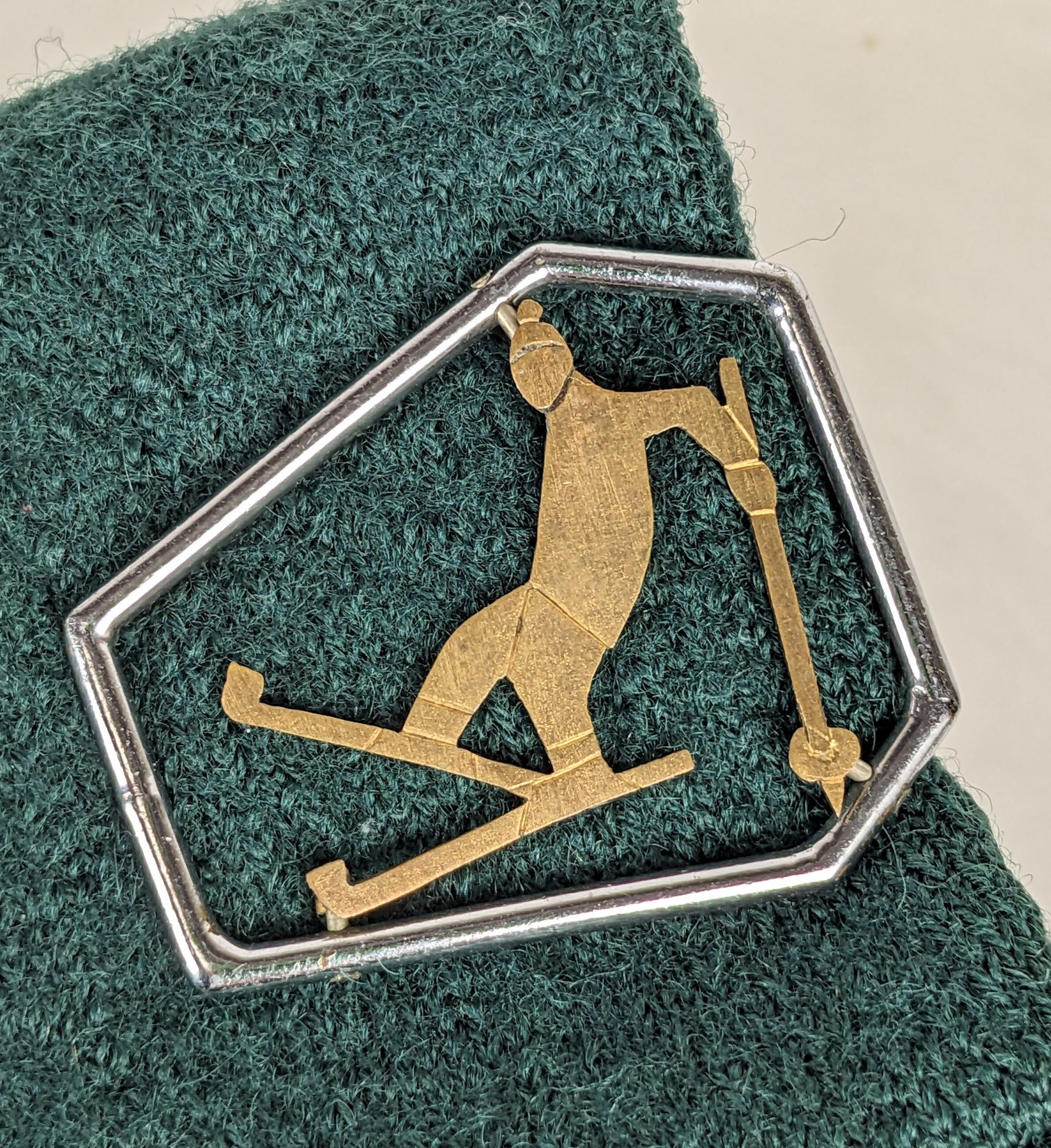 Charming French Art Deco Sport Clip hand made of brushed brass and chrome of a falling skier in the period Deco style. Works best on heavier fabrics on garment areas like neckline or lapel. 
1920's France. 1.75