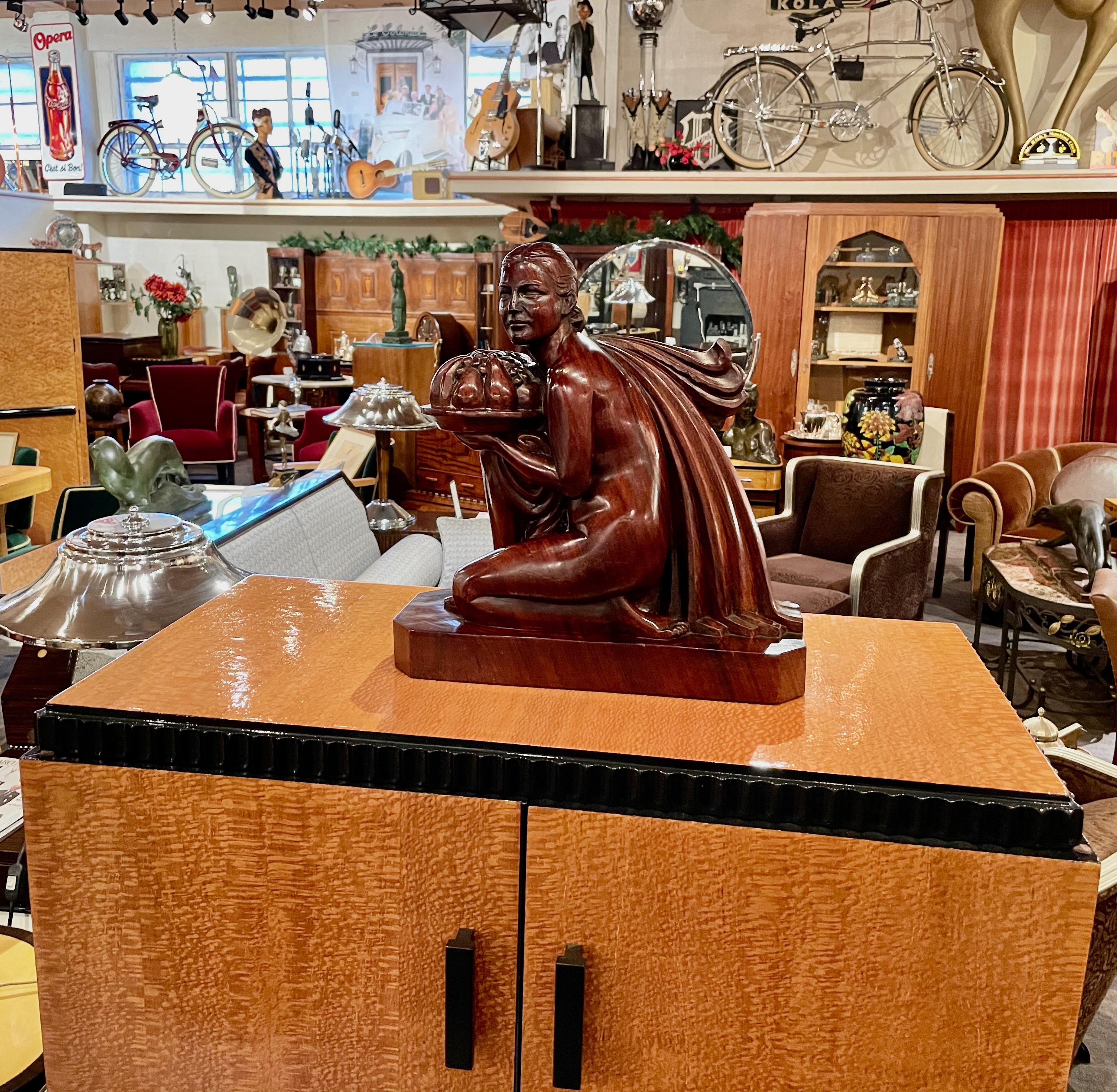 French Art Deco statue hand carved rosewood woman with fruit by G. Verez. Design circa 1925, inspired by the French International Exhibition of Modern Decorative and Industrial Arts (The Exposition Internationale des Arts Décoratifs et Industriels