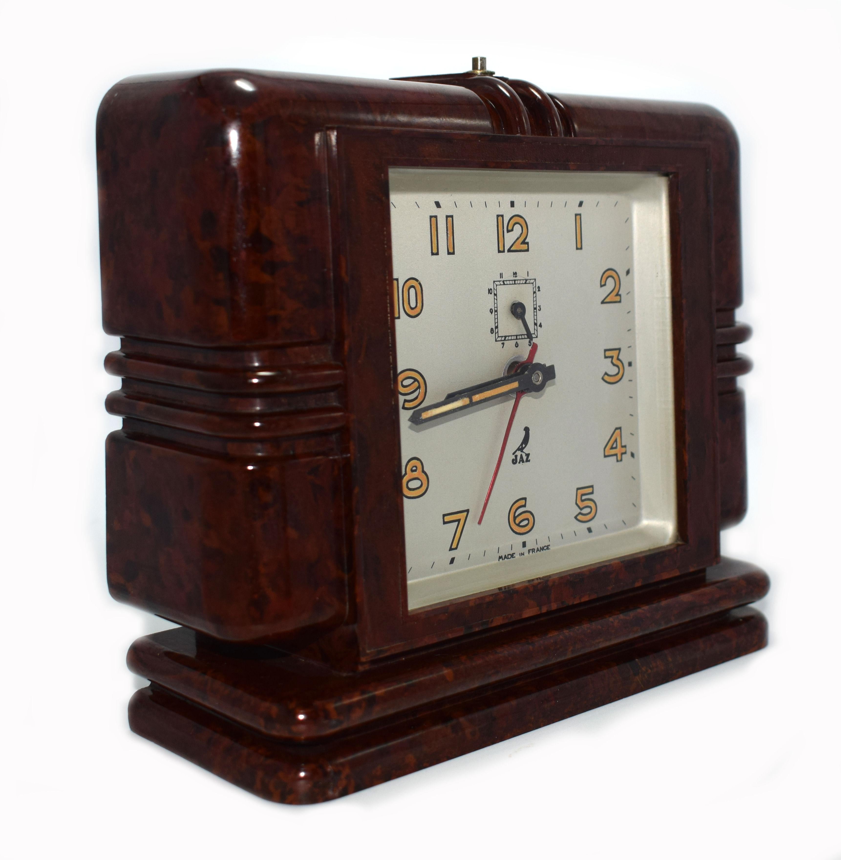 Large and rare 1930s Art Deco bakelite wind up clock by JAZ with the most wonderful bakelite streamline case. This clock is an absolute delight. The Bakelite is a very deep mottled red or brown color and is in excellent condition. The clock as with