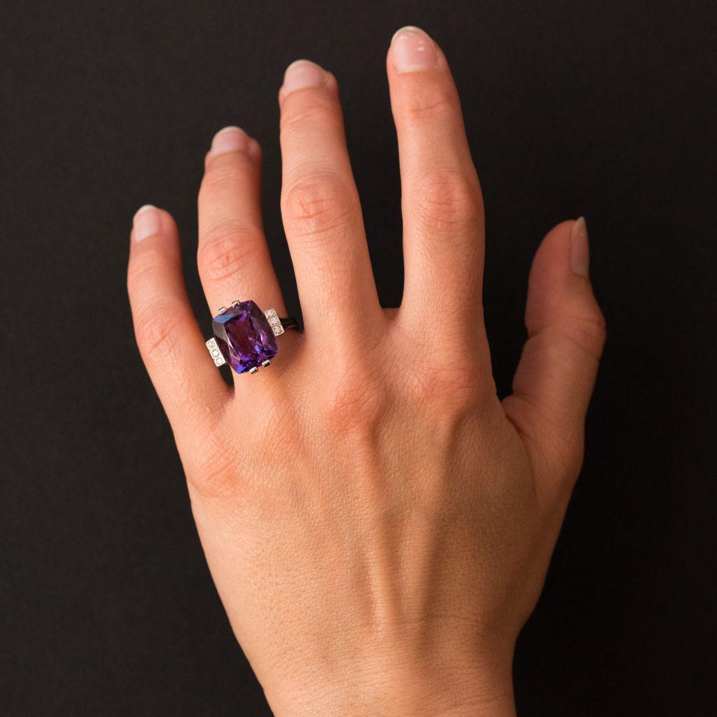 Baume creation - unique piece.
Ring in 18 karat white gold, eagle head hallmark. 
Set with an emerald- cut amethyst and featuring 3 brilliant- cut diamonds set on each side in 3 gold bands that form the start of the ring band. 
Amethyst dimensions: