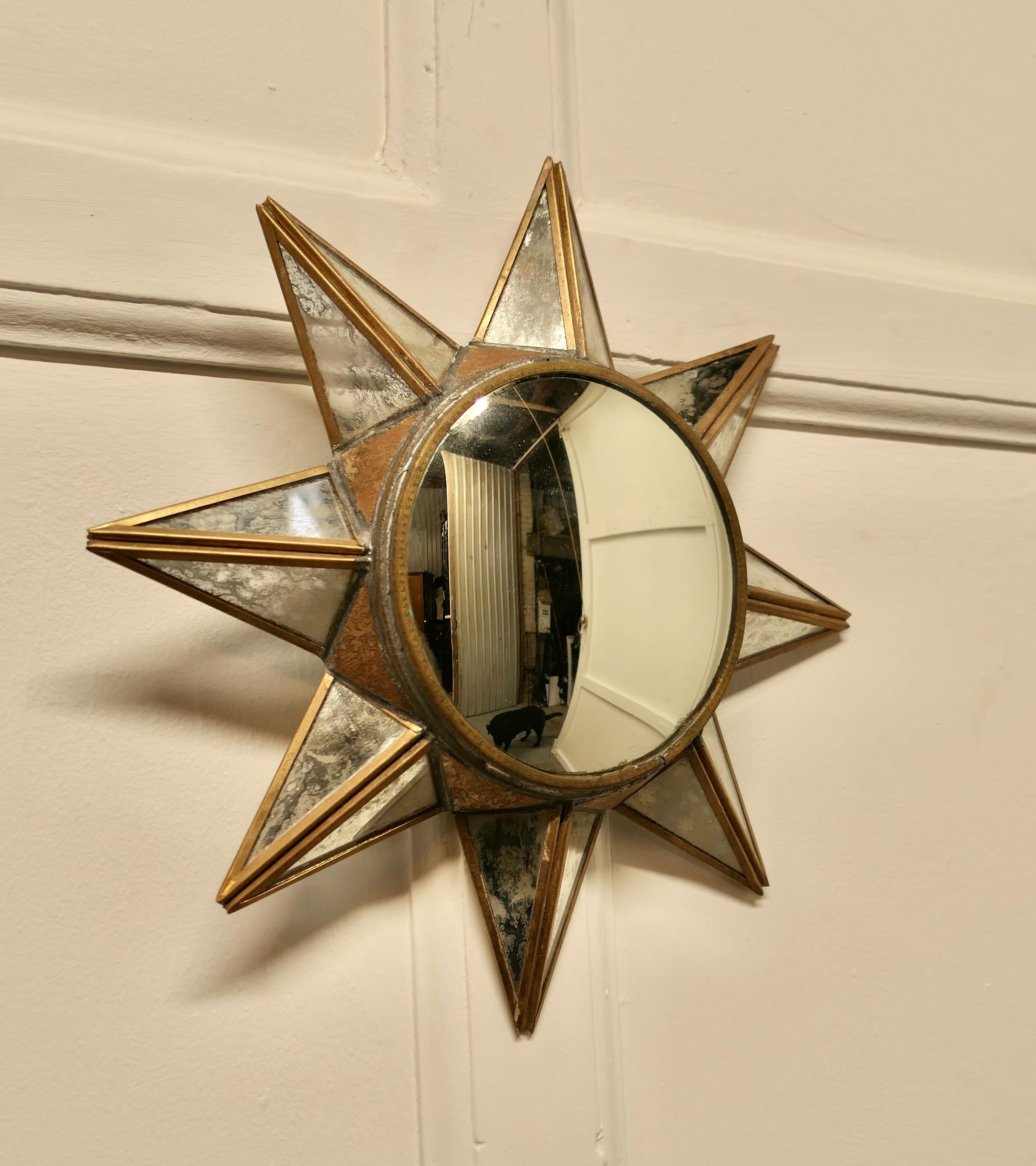French Art Deco style 3D starburst mirror

A Superb stylish piece, the starburst radiates out from the central mirror, each of the 8 rays are double sided forming a triangle in the brass frame 
A Classic design from the 1960s era now an