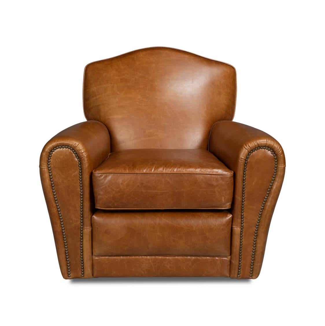 An Art Deco style leather upholstered club chair, in our Vintage Cuba brown leather, with long rolled arms, a padded seat back, and cushions, with detailed nailhead trim and raised on a swivel base.
Dimensions: 36