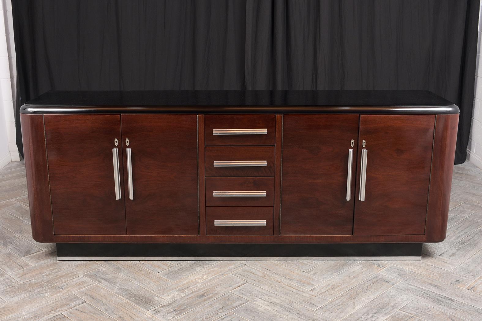 This 1930s French Art Deco-style rosewood buffet has been fully restored and is newly stained dark mahogany and black color combination with a lacquered finish. This buffet has a wooden top with a rounded side design, four small center drawers, and