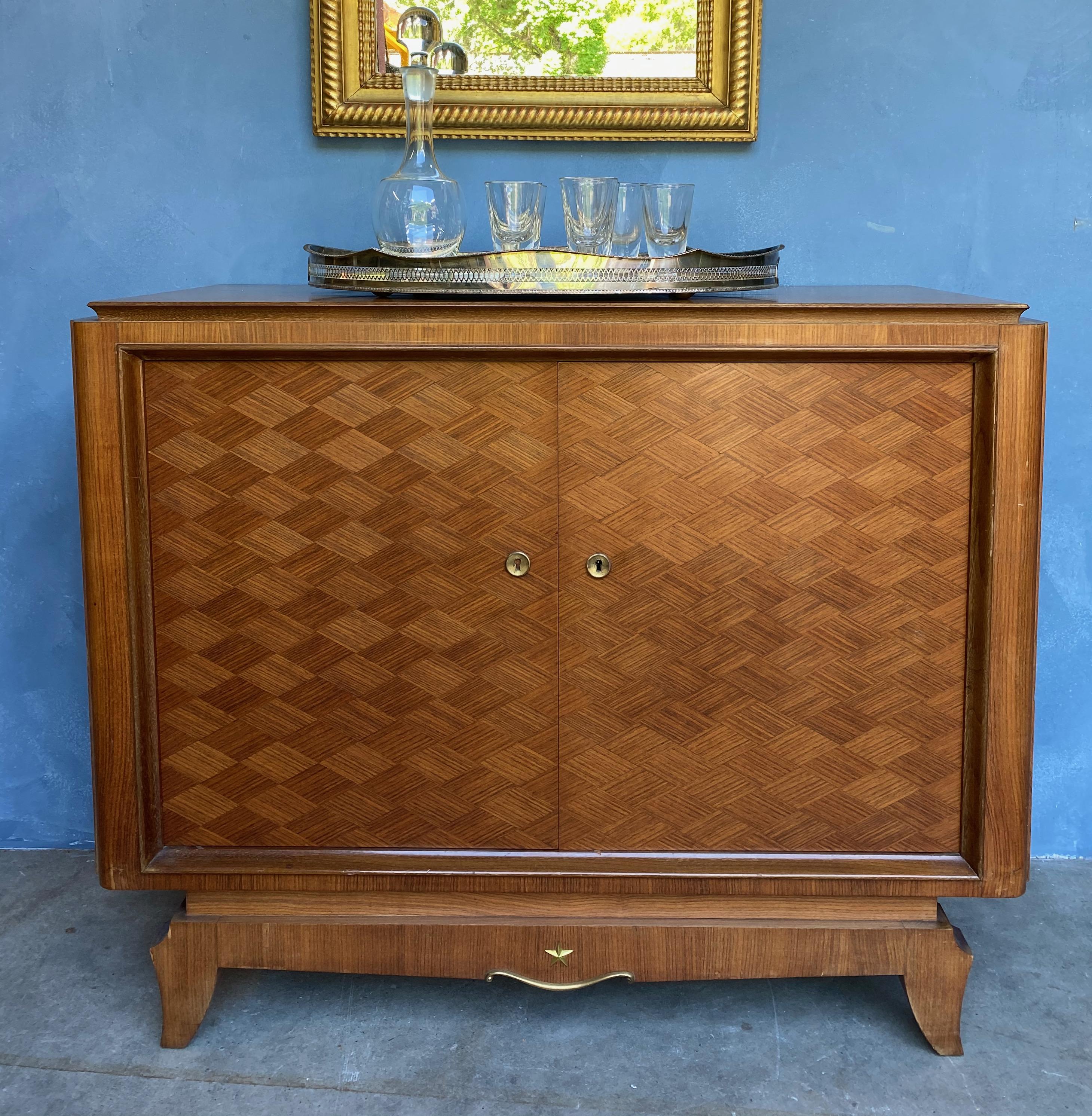 Small French sideboard or server from the late 1940’s. The cabinet is rosewood veneered and sycamore interior. The doors are veneered in diamond shaped rosewood sections that give the piece an interesting geometric effect. The interior of doors are