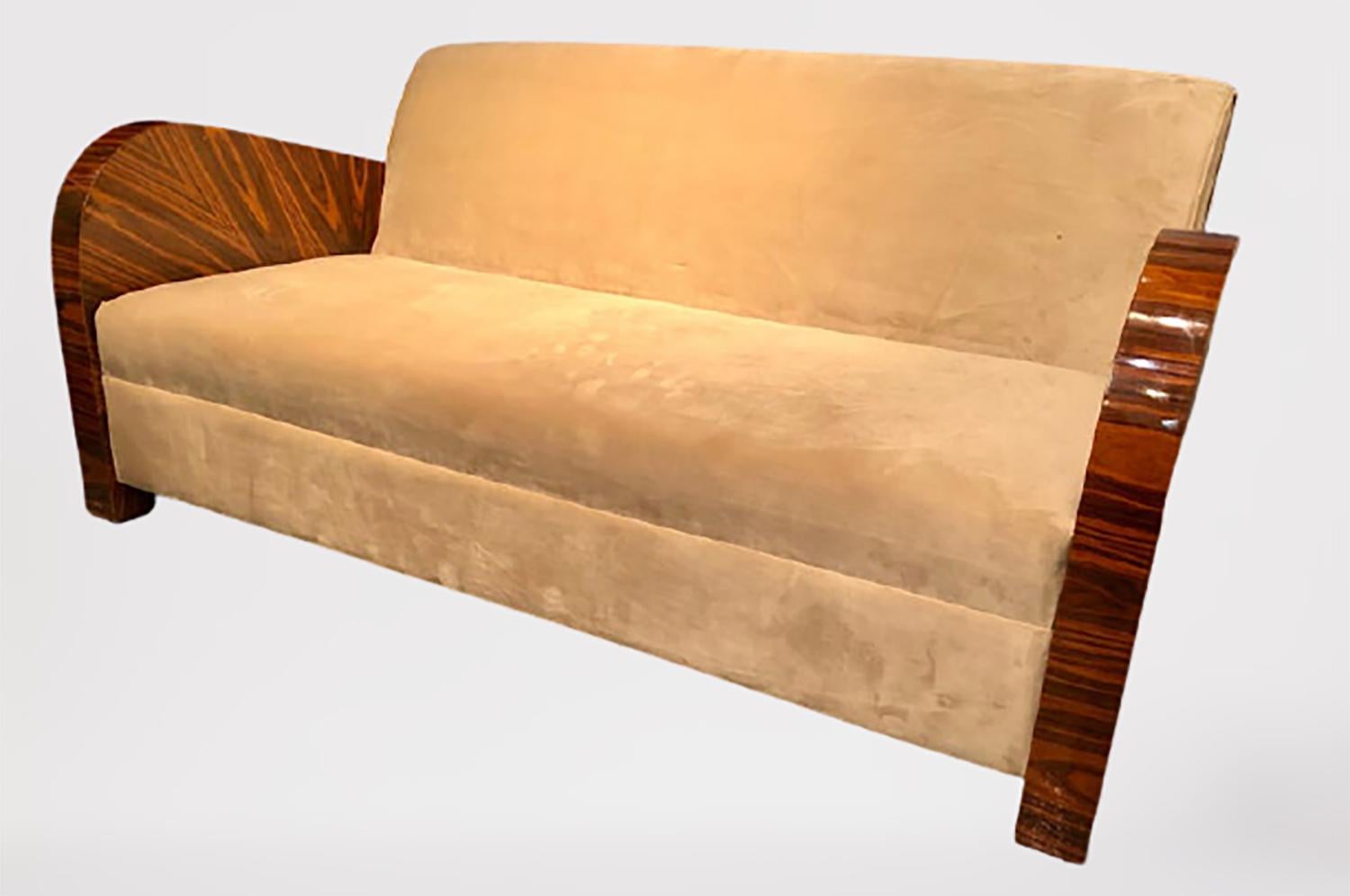 French Art Deco style rosewood sofa/couch having a fine velour upholstery with lacquered rosewood arms. This magnificent sofa or large loveseat is certain to bring charm to any room in the home or office. The large impressive barrel form arm rests