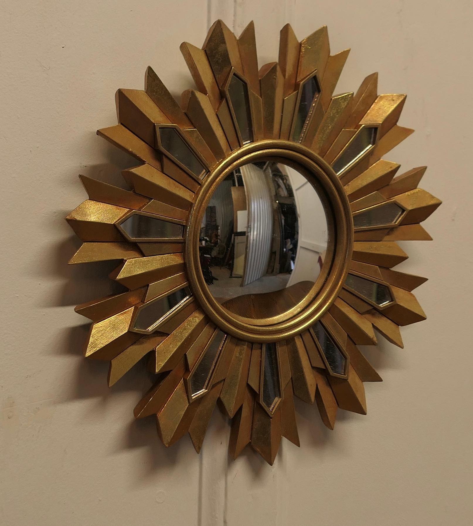French Art Deco Style Sunburst-Starburst Gilt Mirror

A Lovely dainty piece, the starburst or sunburst rays radiate out, the rays are painted in gold and mirror they radiate from the central convex mirror

A Classic design, in good condition 
The