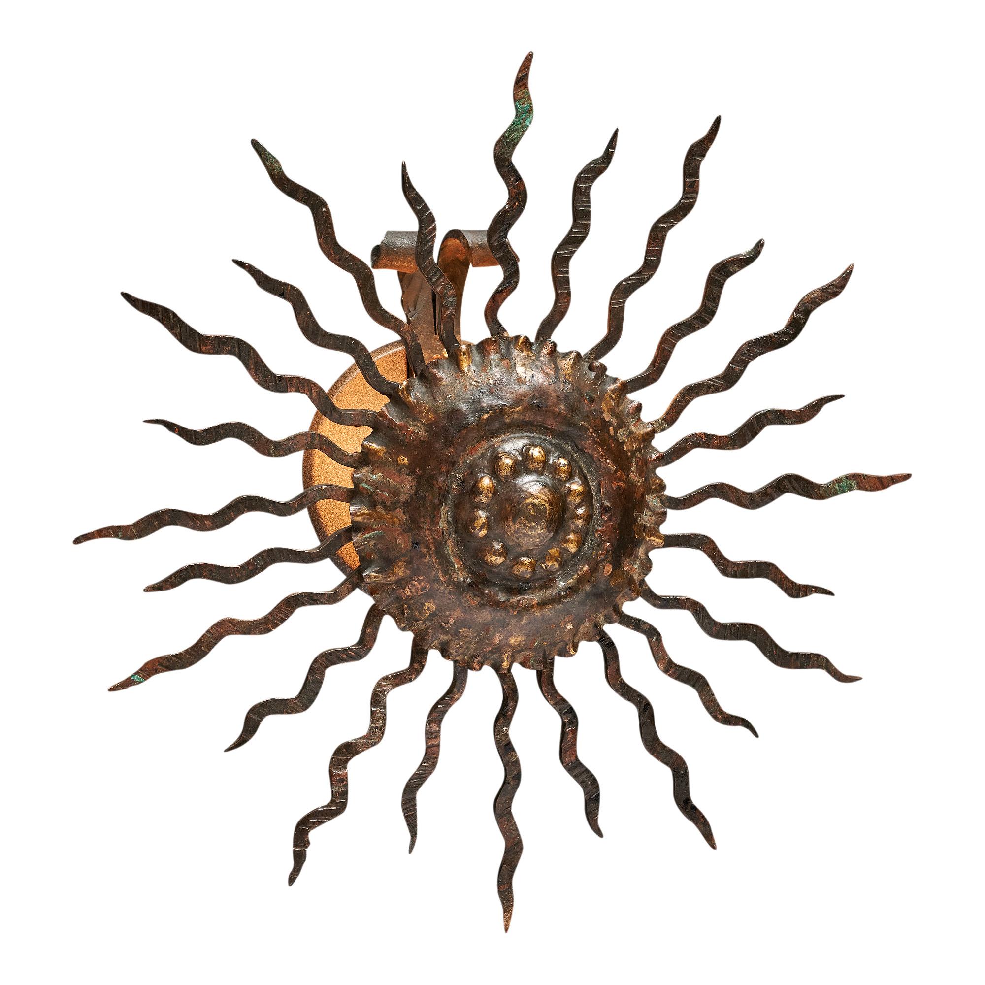 Sconce from the Art Deco period in France. This piece is made of gold-leafed metal in the shape of a sunburst. It has been newly wired to fit US standards. It is in excellent vintage condition – the photos accurately depict the