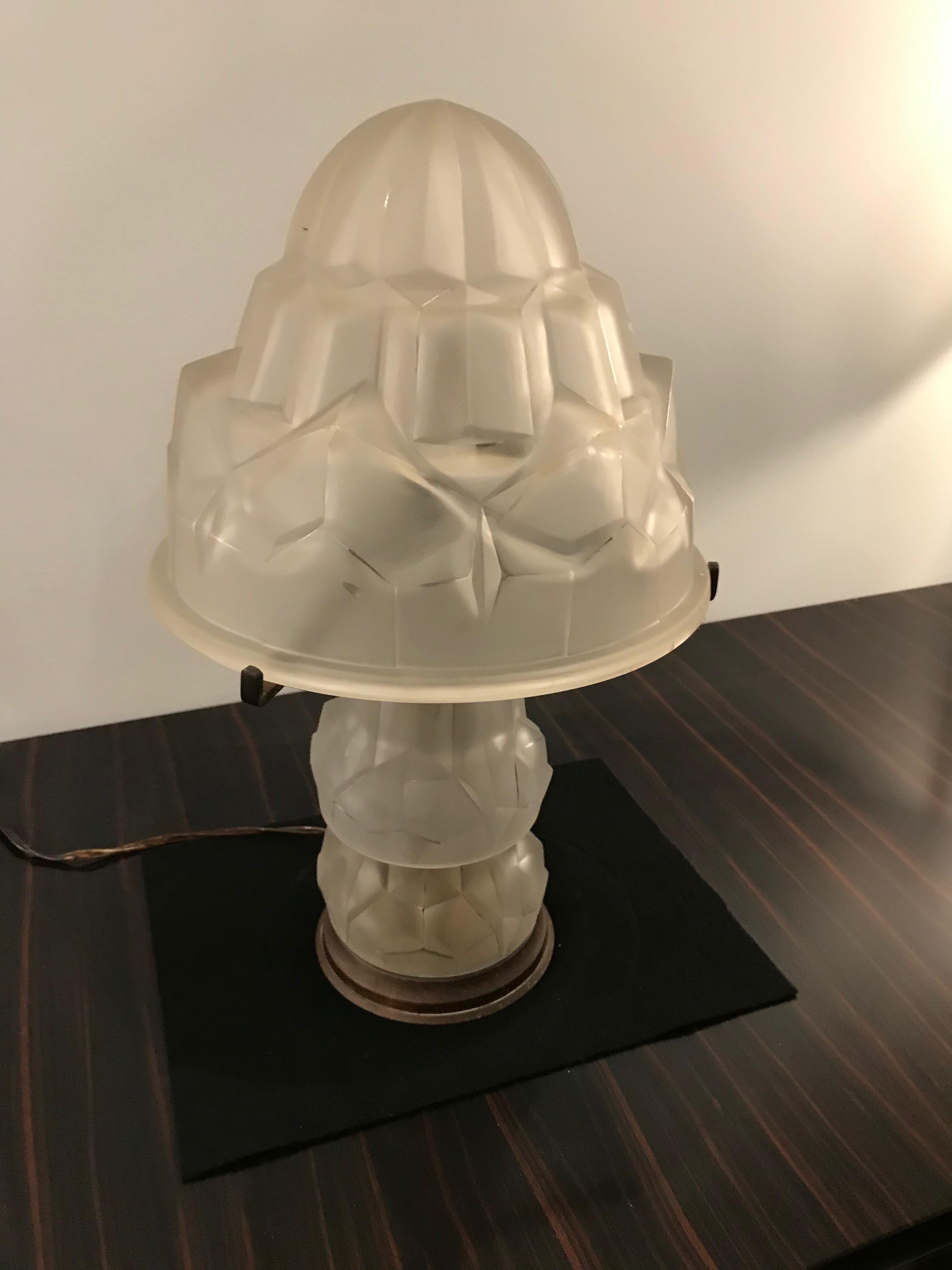 Gorgeous French Art Deco desk / table lamp by Degue. Having geometric shade in frosted glass with polished details. Held by matching glass center shaft that also lights. Has been rewired for American use having two candelabra socket. With a max watt