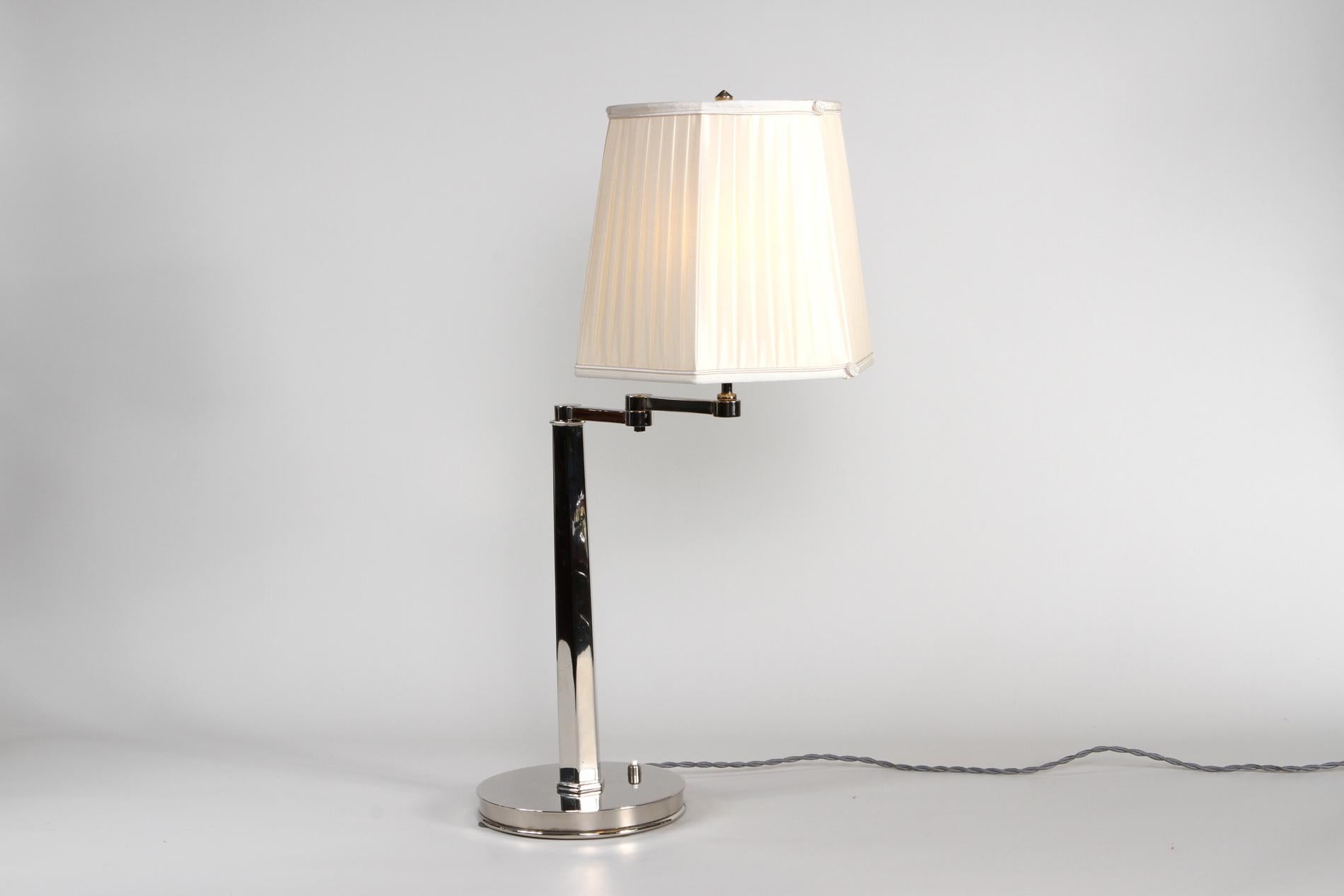 Original table lamp by Maison Dominique, modernist style in nickeled bronze and custom made creamy lampshade. The lamp is great for desks or nightstands as it's totally articulated and we can play with the shades of the light, creating a really