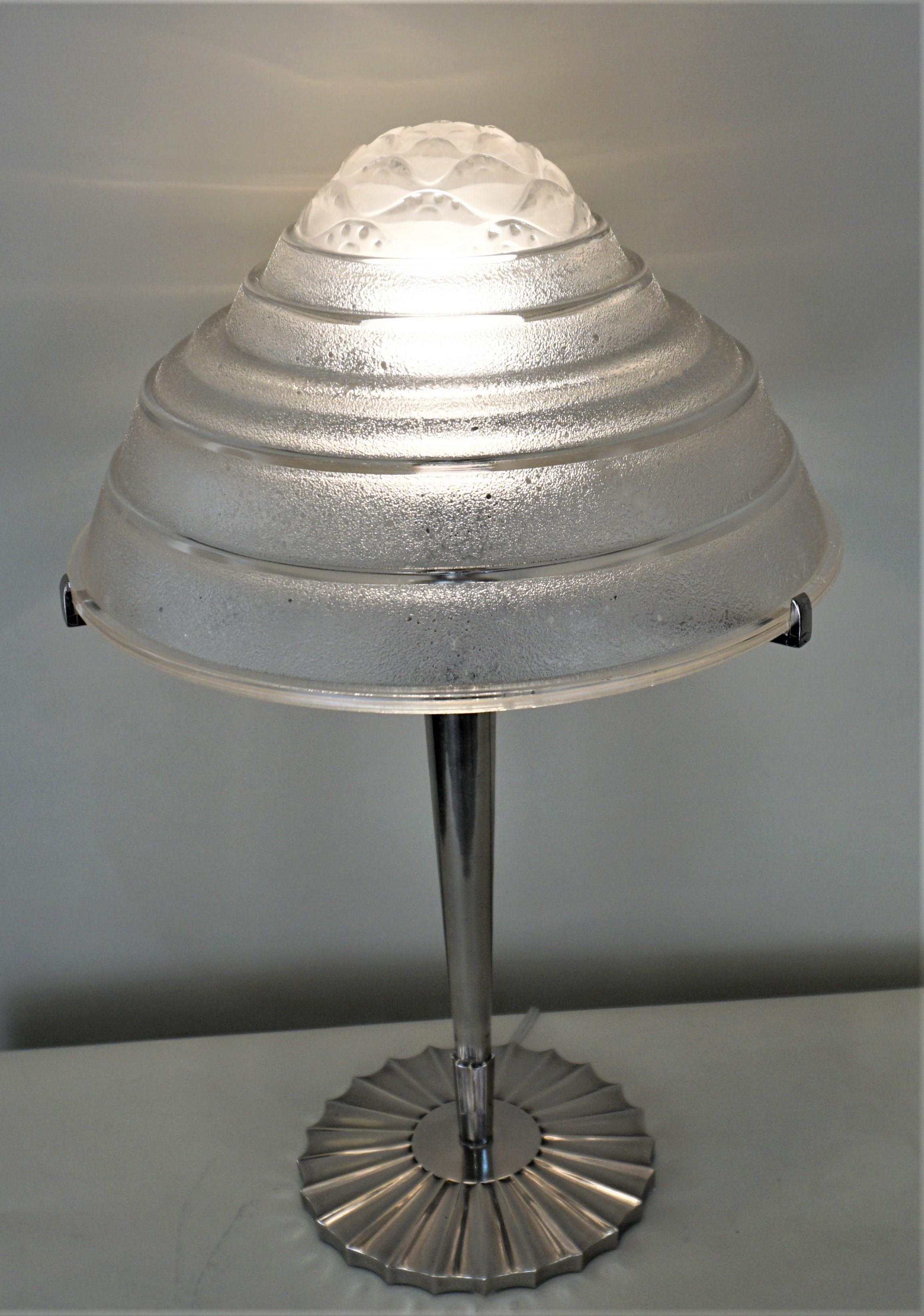 Molded clear glass with acid cut texture, nickel on bronze base art deco table lamp.
