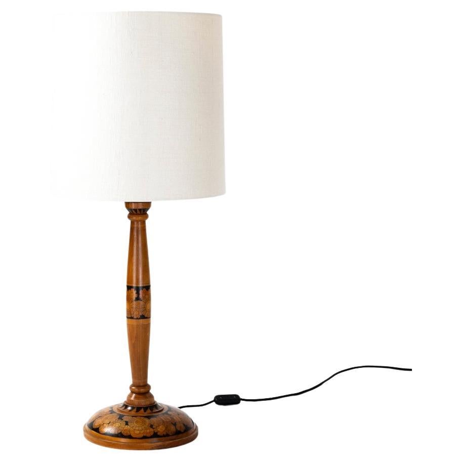 The lamp base has a classic shape.
The base has a small rim and a raised curve (diameter foot 24cm) on this curvature are various hand painted 
floral flower elements in different sizes and colors - with a black background. 
The lower shaft has a