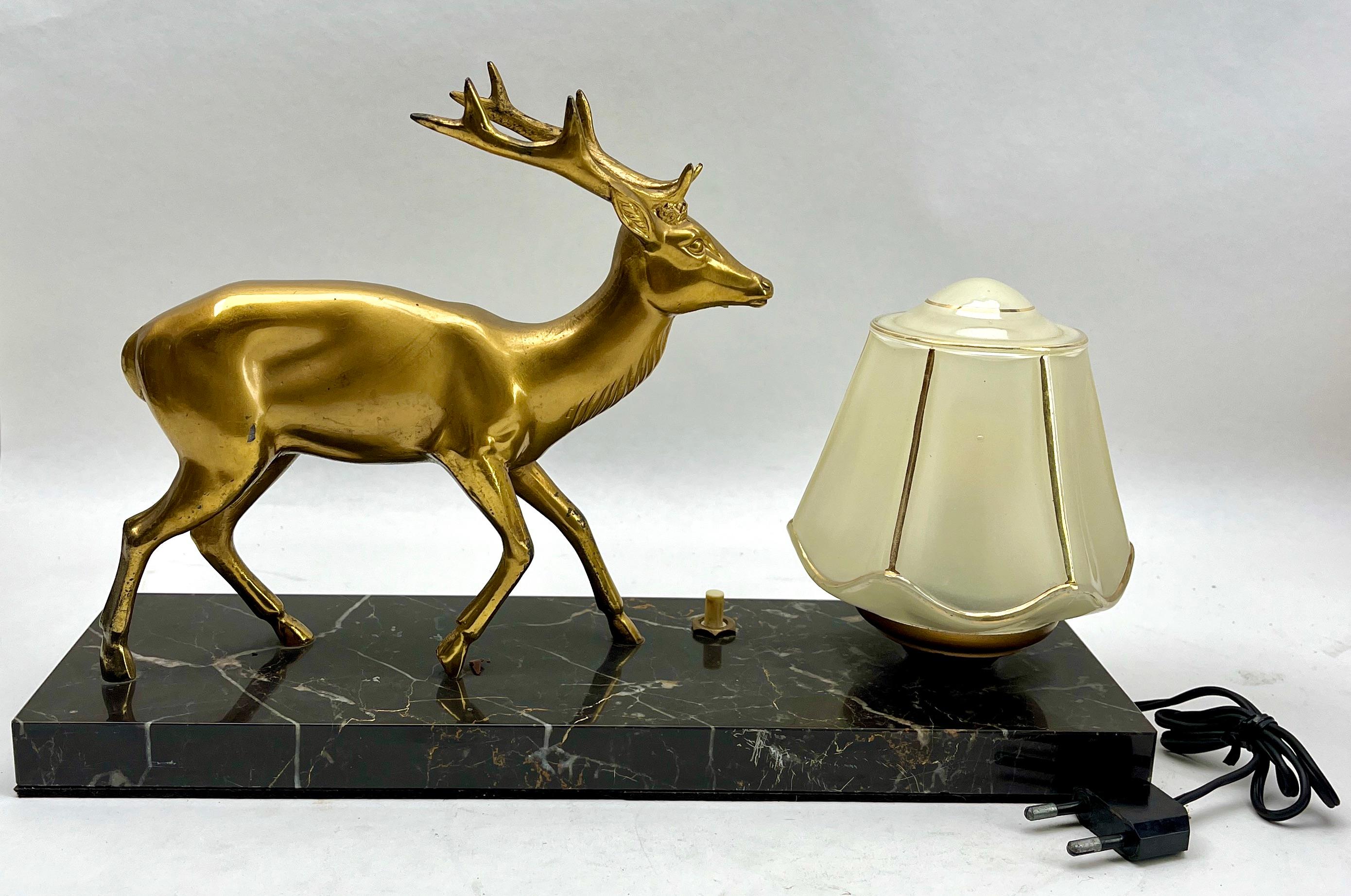 Stunning French Art Deco table lamp Gorgeous glass globe shade.
With Spelter Deer motif. Sitting on a marble base. 
In excellent condition and in full working order. And fitting E14 

The piece is in excellent and original condition and a real