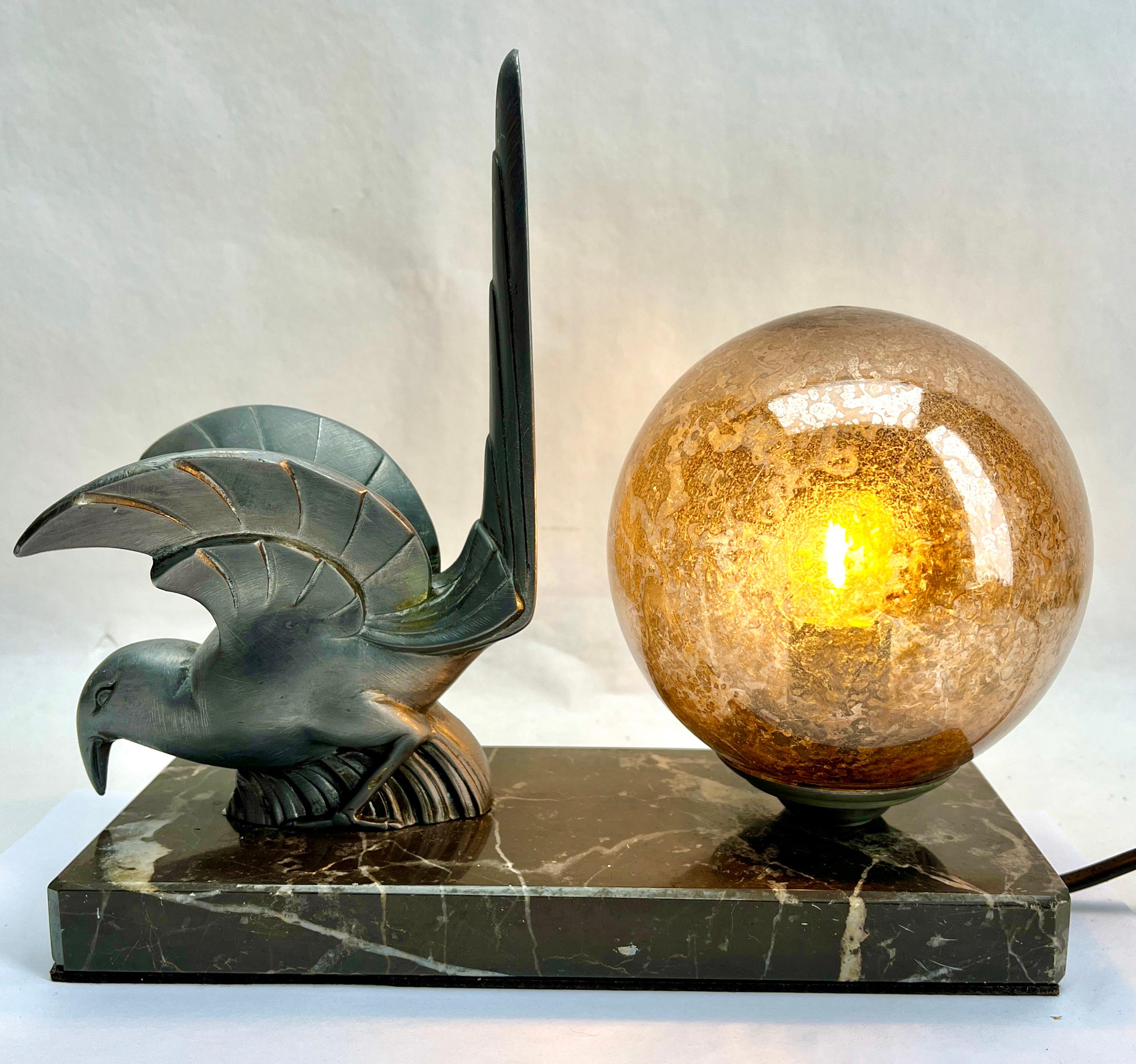 Stunning French Art Deco table lamp Gorgeous glass globe shade.
With Spelter Bird motif. Sitting on a marble base. 
In excellent condition and in full working order. 
Rewiring and Fitting E14
Originel Patina on all Parts
The piece is in excellent