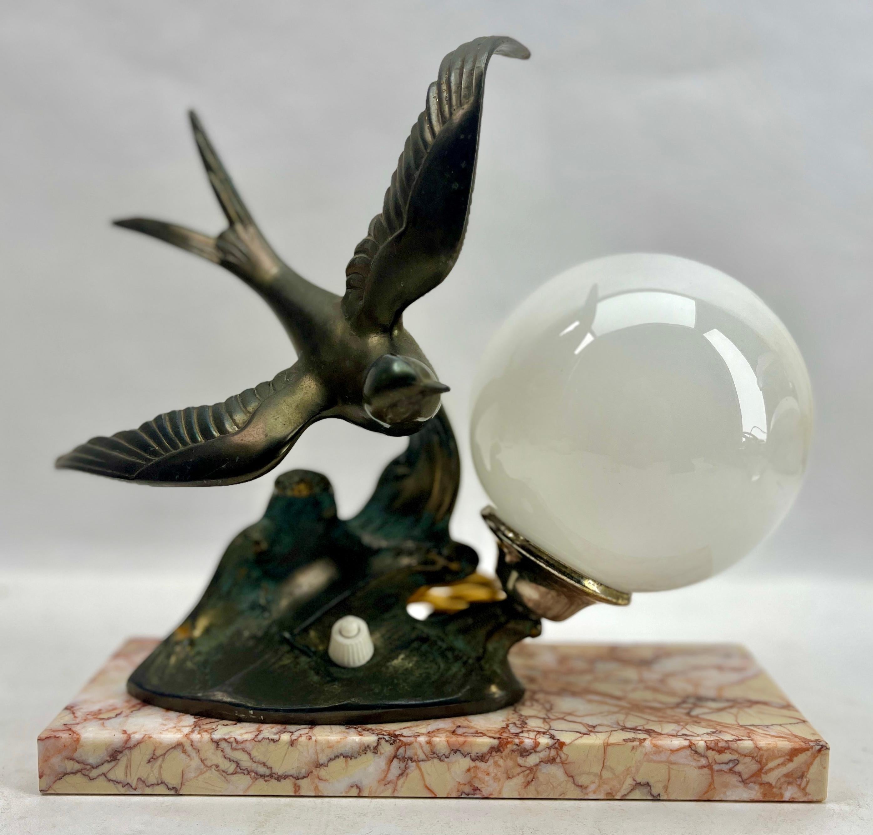 Stunning French Art Deco table lamp Gorgeous glass globe shade.
With Spelter Bird motif. Sitting on a marble base. 
In excellent condition and in full working order. 
Rewiring and Fitting E14
Originel Patina on all Parts
The piece is in excellent