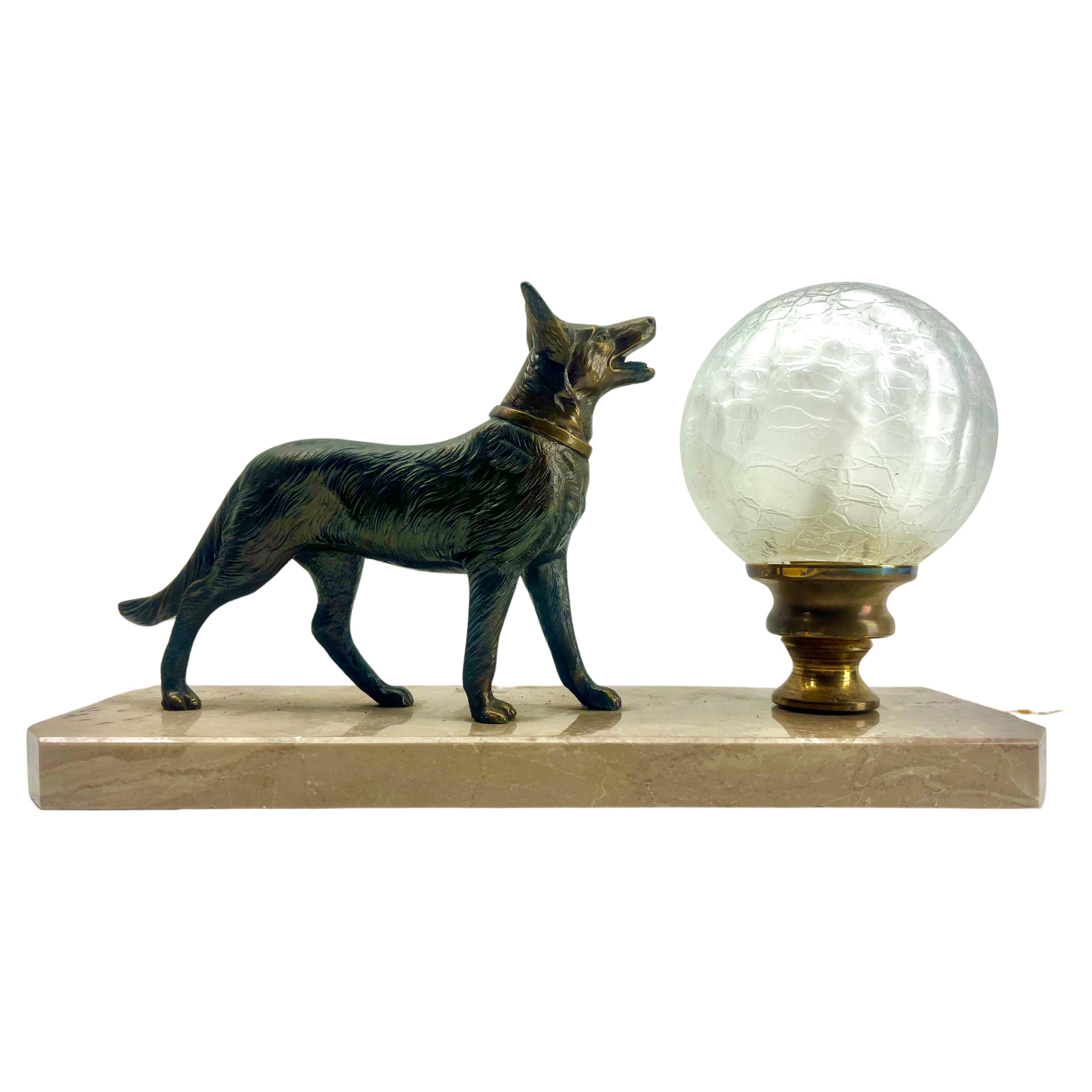 Stunning French Art Deco table lamp Gorgeous glass globe shade.
With Spelter Dog motif. Sitting on a marble base. 
In excellent condition and in full working order. 
Rewiring and Fitting E14
Originel Patina on all Parts
The piece is in Good and