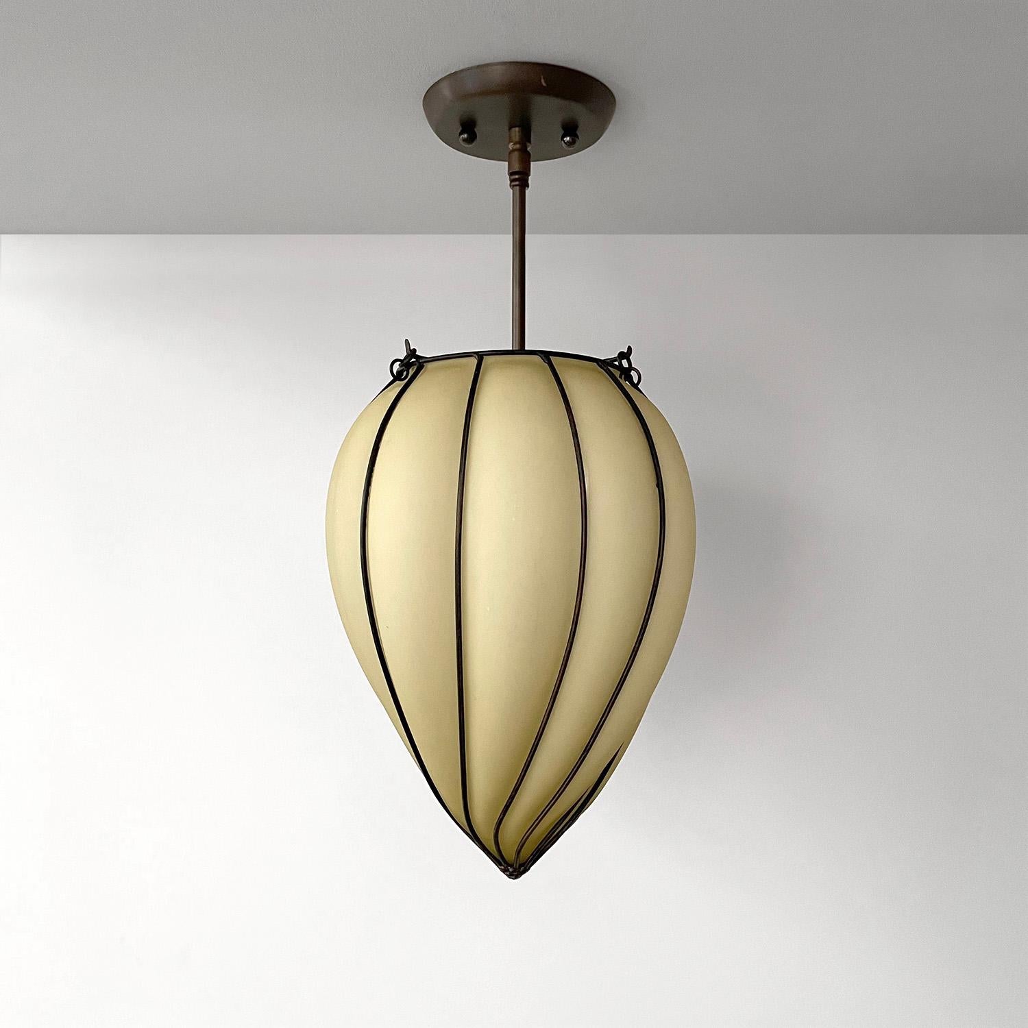 French Art Deco teardrop pendant ceiling light
France, 1930’s 
Handblown molded teardrop shape shade encompassed in a sculpted iron frame
Illuminates light beautifully 
Small area with indentation created in the manufacturing process
Please