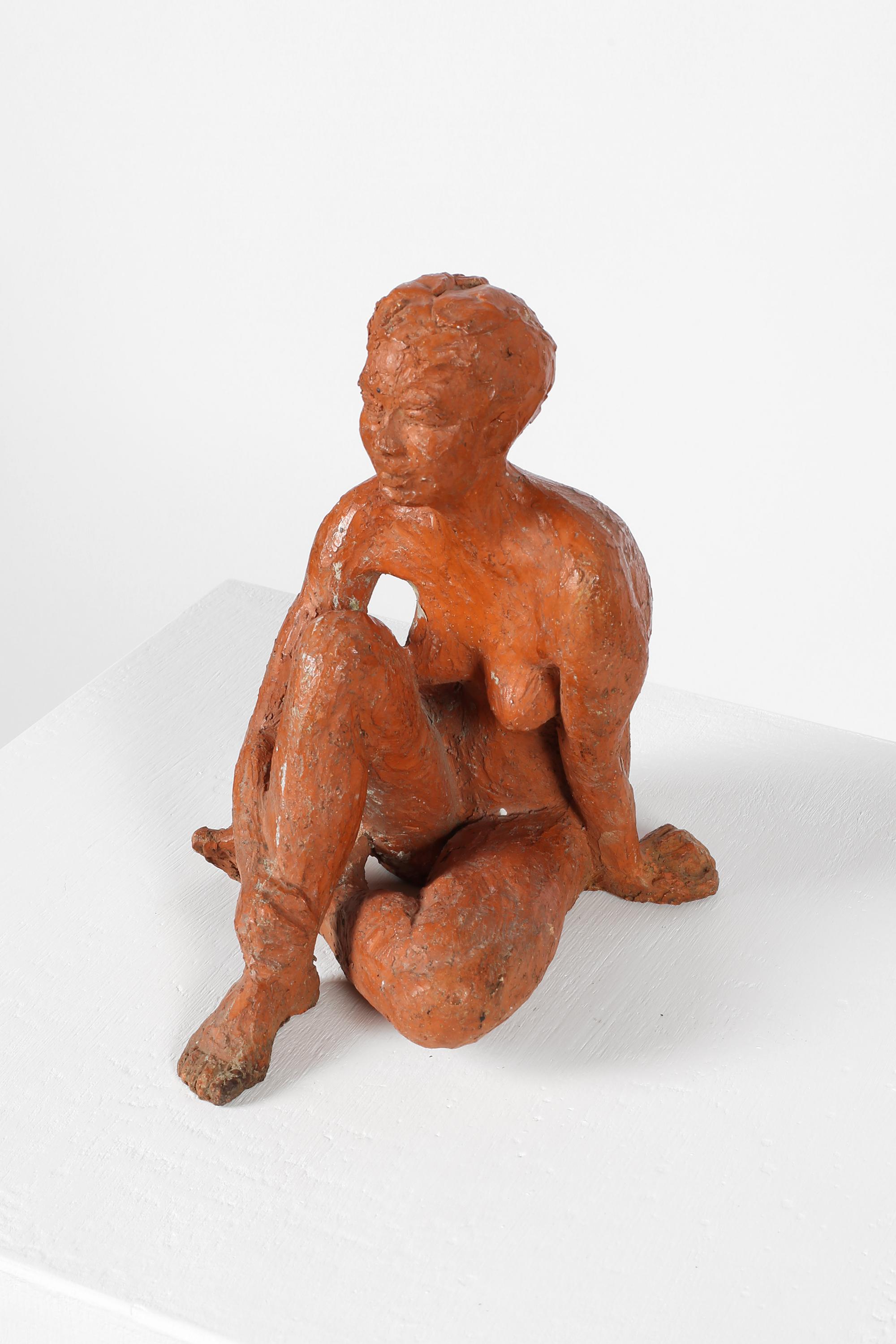 A terracotta sculpture depicting a sitting female nude, attributed to Gabriel Eugène Coquelin (1907-1996). French, c. 1930s.