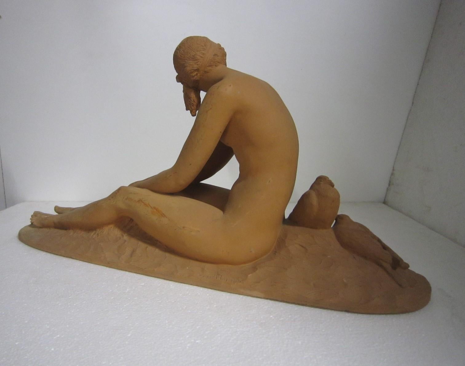 A fine French Art Deco original sculpture of a nude seated on an oval, racetrack shaped self plinth.
The female nude reclines bare chested alongside a pair of dove birds by her side, with a sweet but seductive demeanor, in a soft nude terracotta