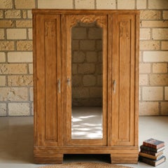 French Art Deco Three-Door Oak Armoire, Carved Florals, Beveled Mirror, 1930s