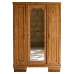 French Art Deco Three-Door Oak Armoire, Carved Florals, Beveled Mirror, 1930s