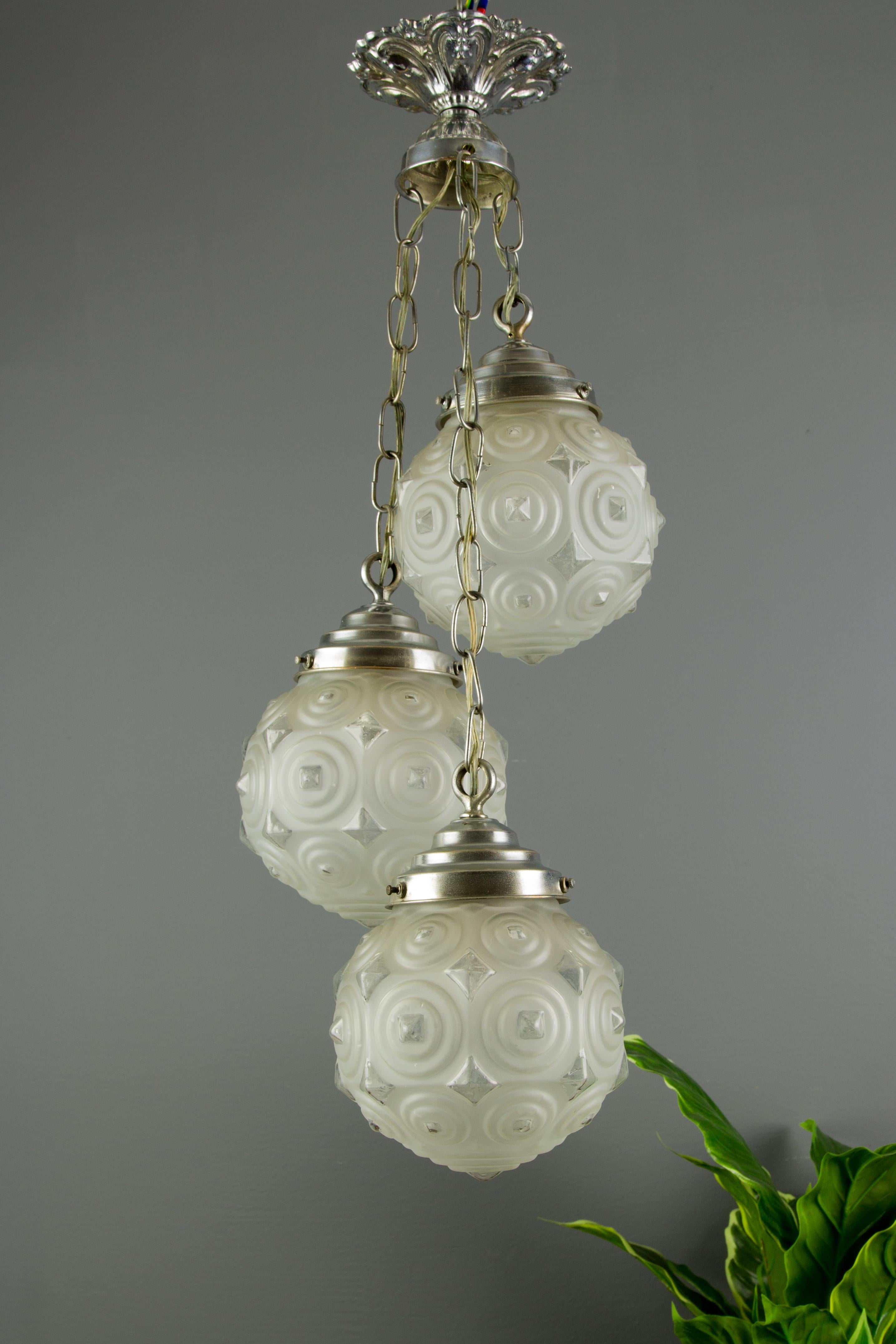 Early 20th Century French Art Deco Three-Light Frosted Glass and Brass Cascade Pendant Light