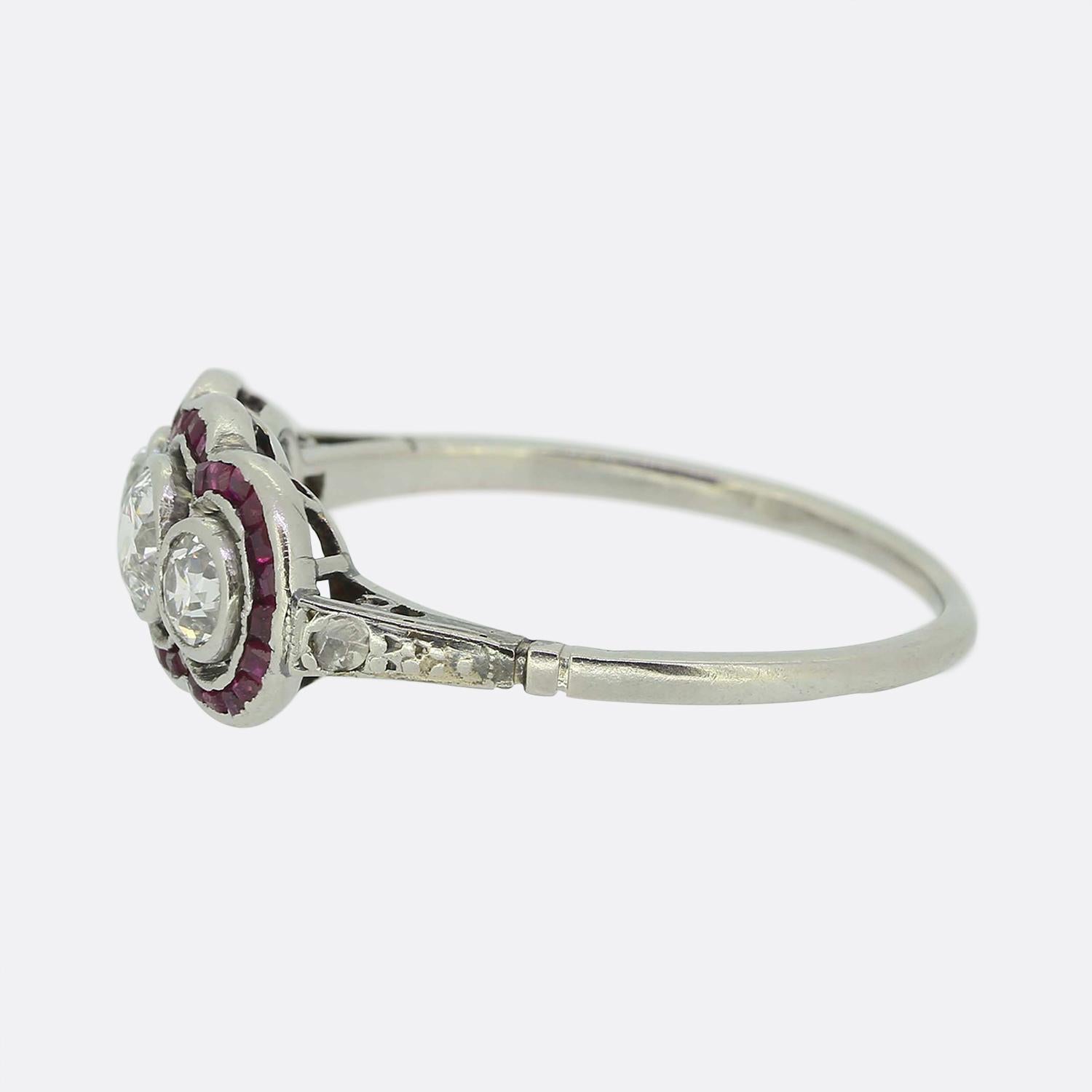 Here we have a gorgeous French Art Deco three- stone diamond ring. A trio of bright white round faceted old European cut diamonds have been individually bezel set at the centre of an open face in a slight concave fashion and then accentuated by a