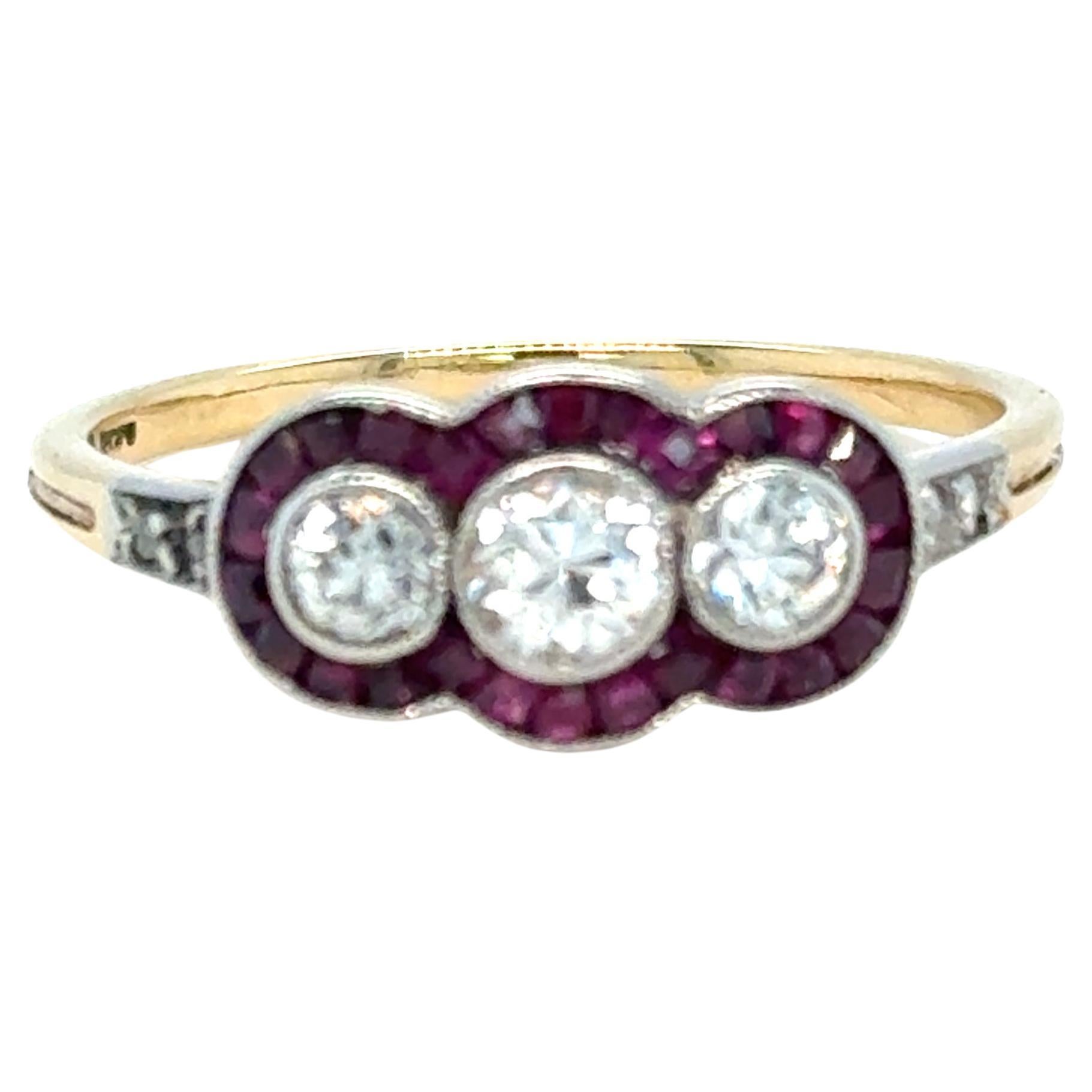 This stunning French Art Deco ring exudes timeless sophistication and expert craftsmanship. At its centre, three dazzling old European cut diamonds (approx. 0.66ct total) are elegantly bezel-set in a slight concave arrangement, creating a