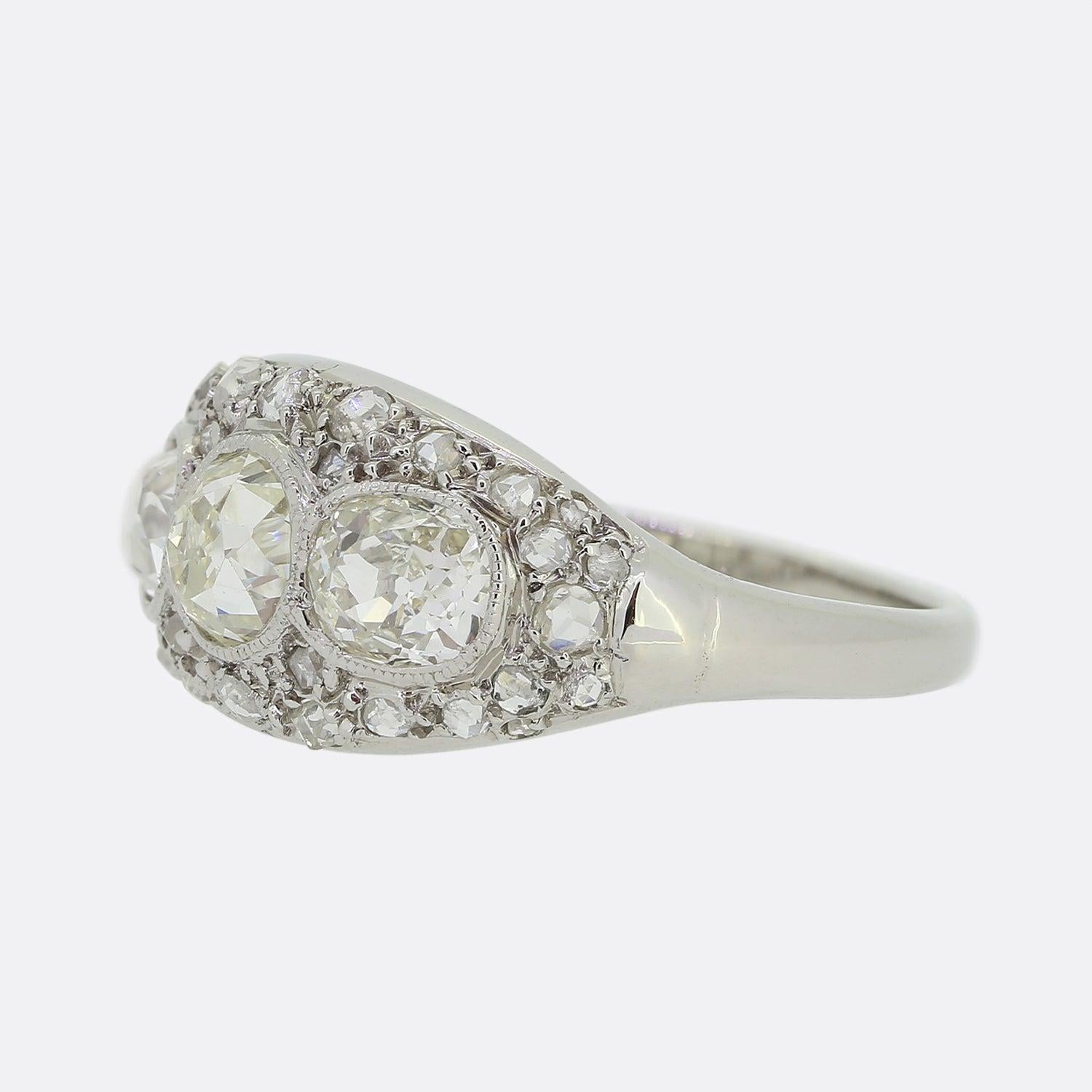 Here we have an impressive three-stone diamond ring crafted in France at a time when the Art Deco style was at the height of design. A chunky old mine cut diamond sits at the centre of the face with a single old European cut diamond for company on