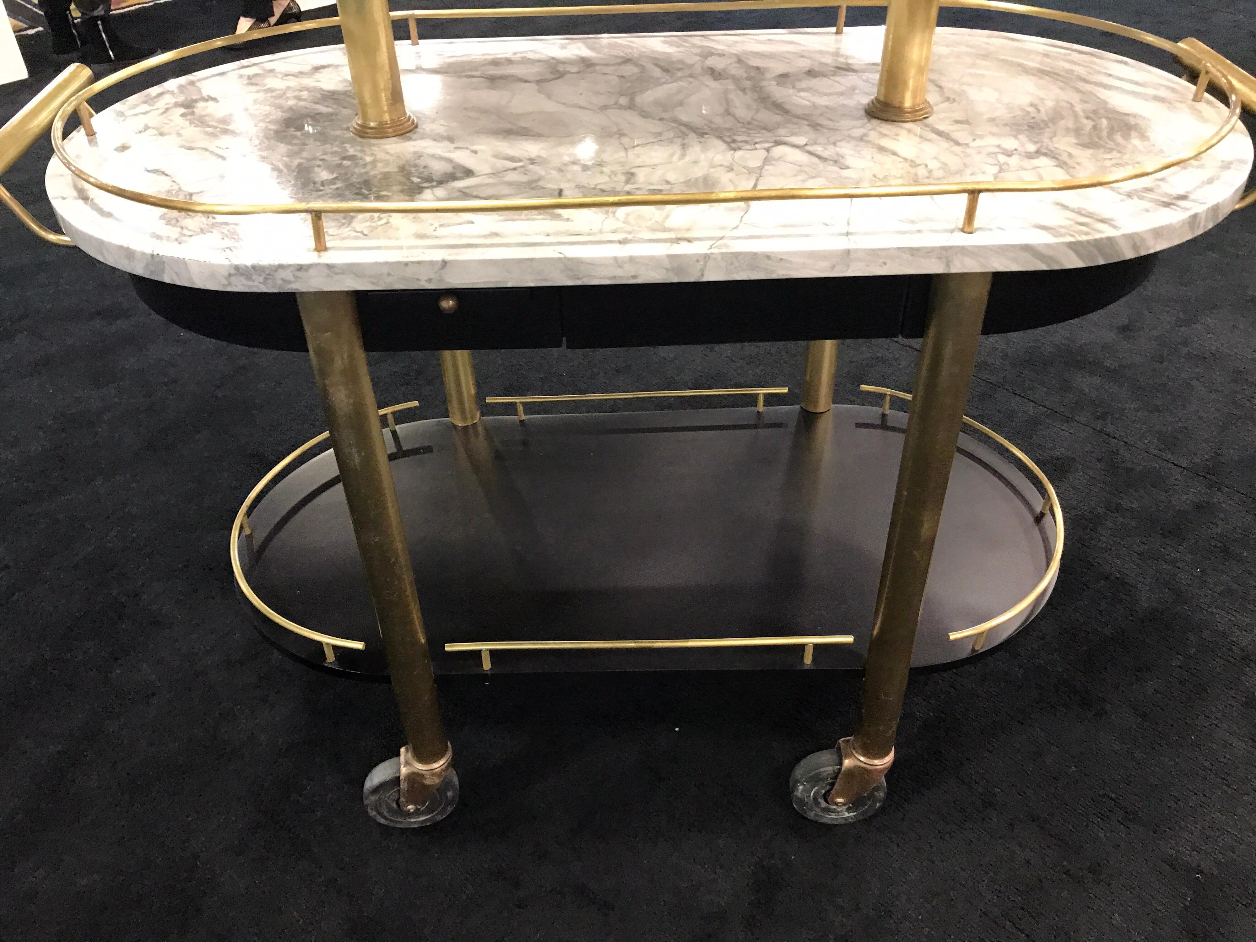 French Art Deco three-tier brass and marble Bistro cart, fitted with three brass gallery tiered shelves.
The top marble shelf measures 35