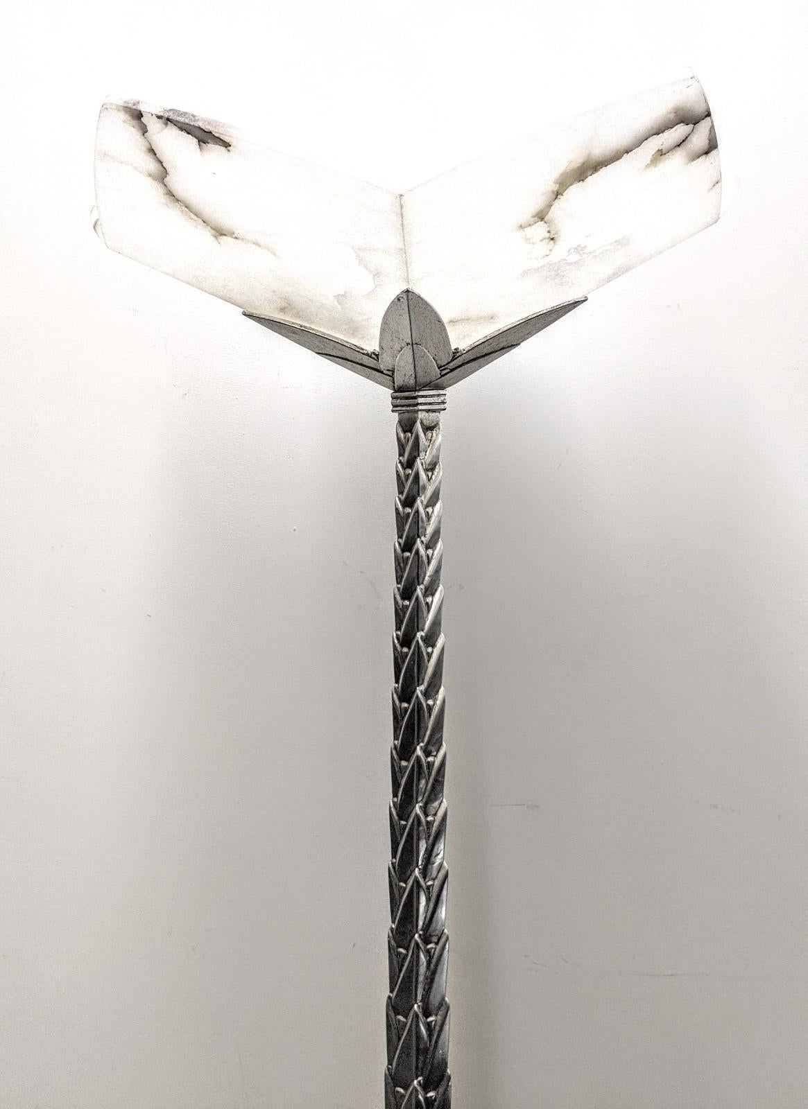 Stunning French Art Deco torchère, floor lamp with a fluted stem of Palm Tree Design in silver with Alabaster shade. The lamp has been rewired for U.S. standards, with a household bulb E-26 medium base (300 Watt max.) Measures: 77” High x 25”