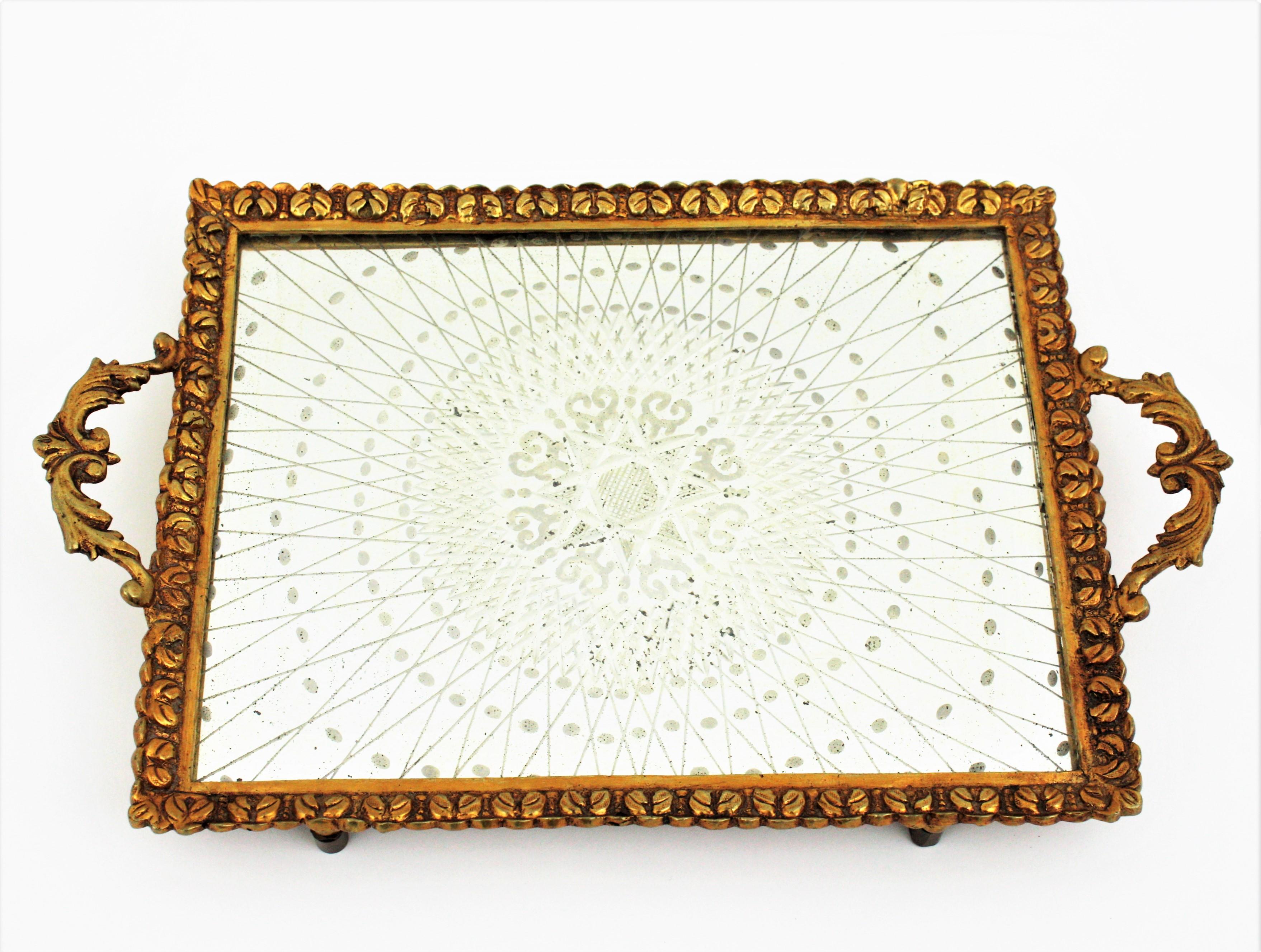 Amazing early 20th century Rectangular Art Deco carved bronze tray with handles and etched mirror top, France, 1930s-1940s.
This mirrored serving tray or vanity tray features a rectangular bronze frame with carving floral details thorough and