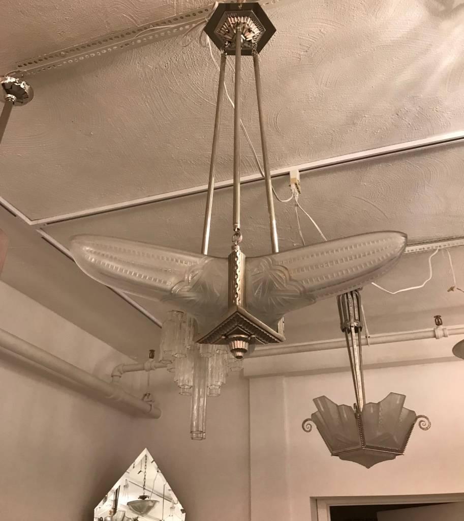 French Art Deco triangular starburst chandelier. Having three clear frosted molded glass panels having geometric motif with polished details. Held by a silvered polish nickel bronze frame with a geometric design. Has been rewired for American use
