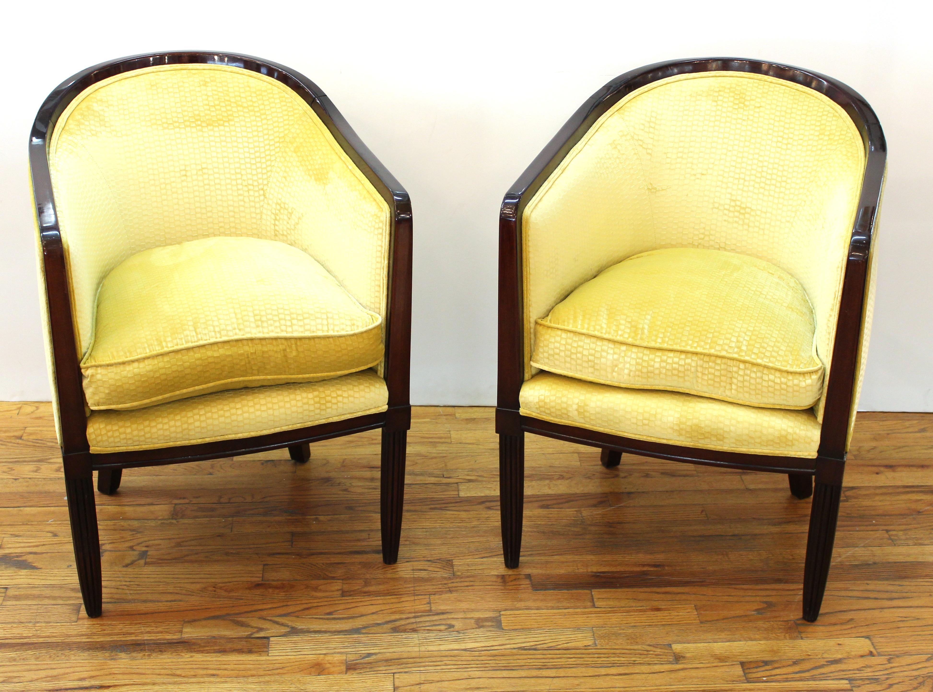 French Art Deco pair of tub chairs in ebonized wood with fluted front legs and mustard yellow velvet upholstery with gauffrage effect.