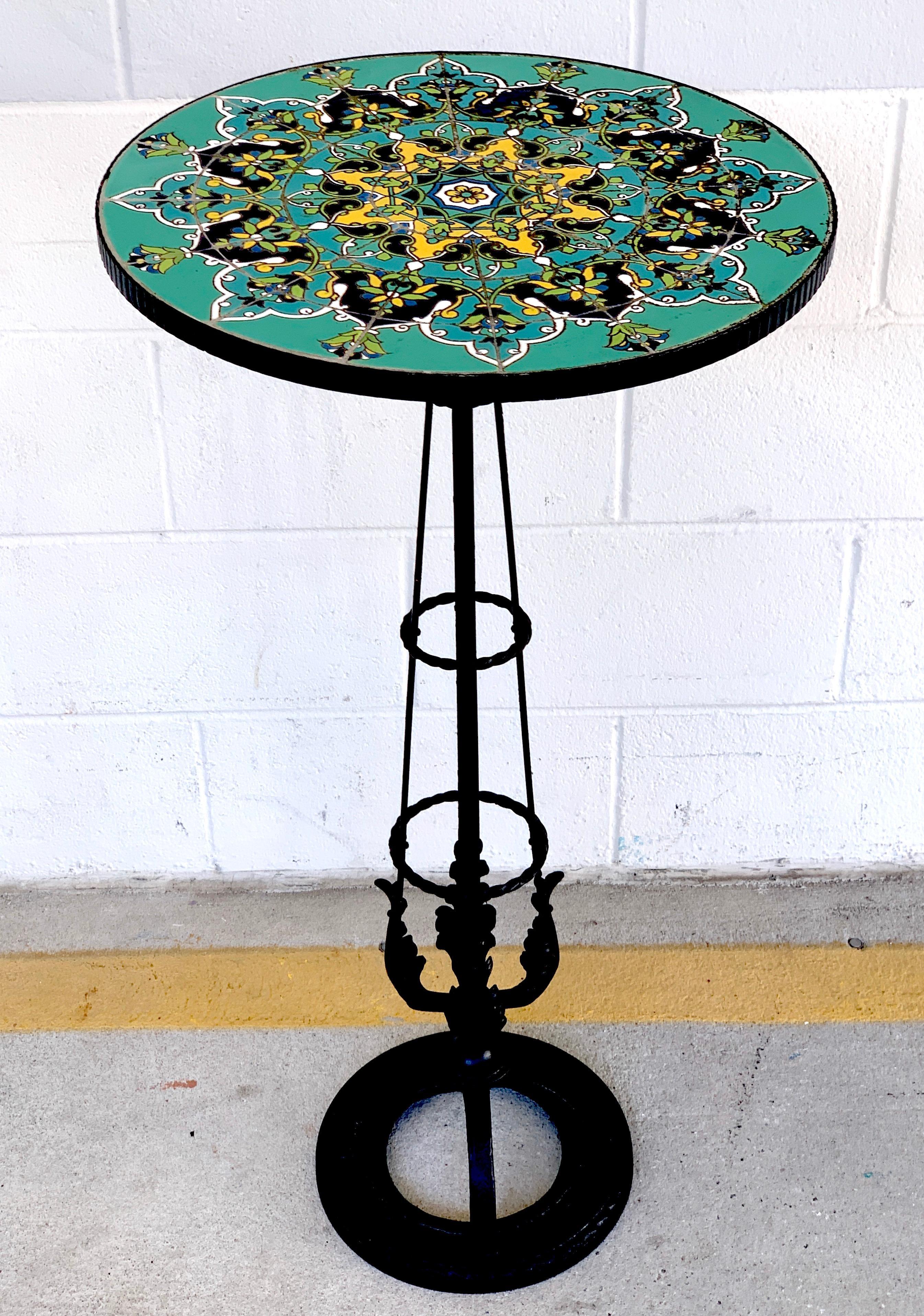 French Art Deco turquoise tile and wrought iron pedestal table, with exquisite enameled 18-inch circular top on a tapering wrought iron pedestal resting on a 11-inch diameter base.
 