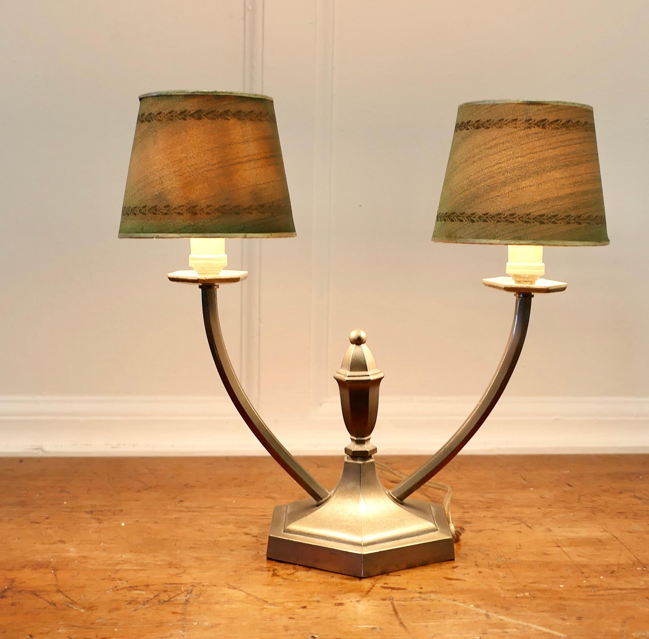 French Art Deco Twin Table Lamp

This is a charming piece, it is made in Steel and has 2 wide branches each topped with a delightful decorated Green paper shade
All in good working condition with an age related patina

The lamp is 12” tall, 13”