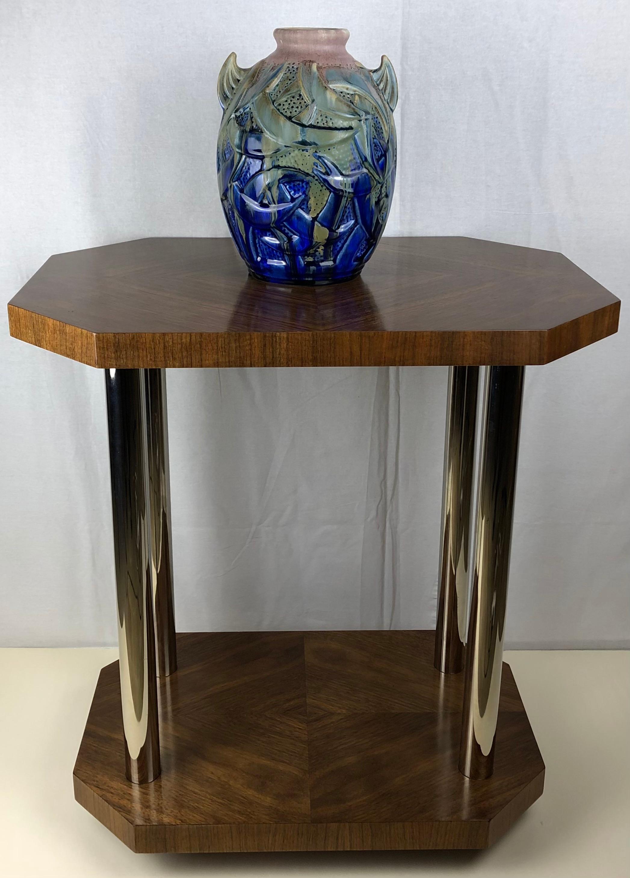 Original sleek designed French two-tiered Art Deco side table.

This beautiful table is made of walnut veneer that has been completely refinished. The top and bottom shelf both feature a perfectly centered diamond shape design. There are four