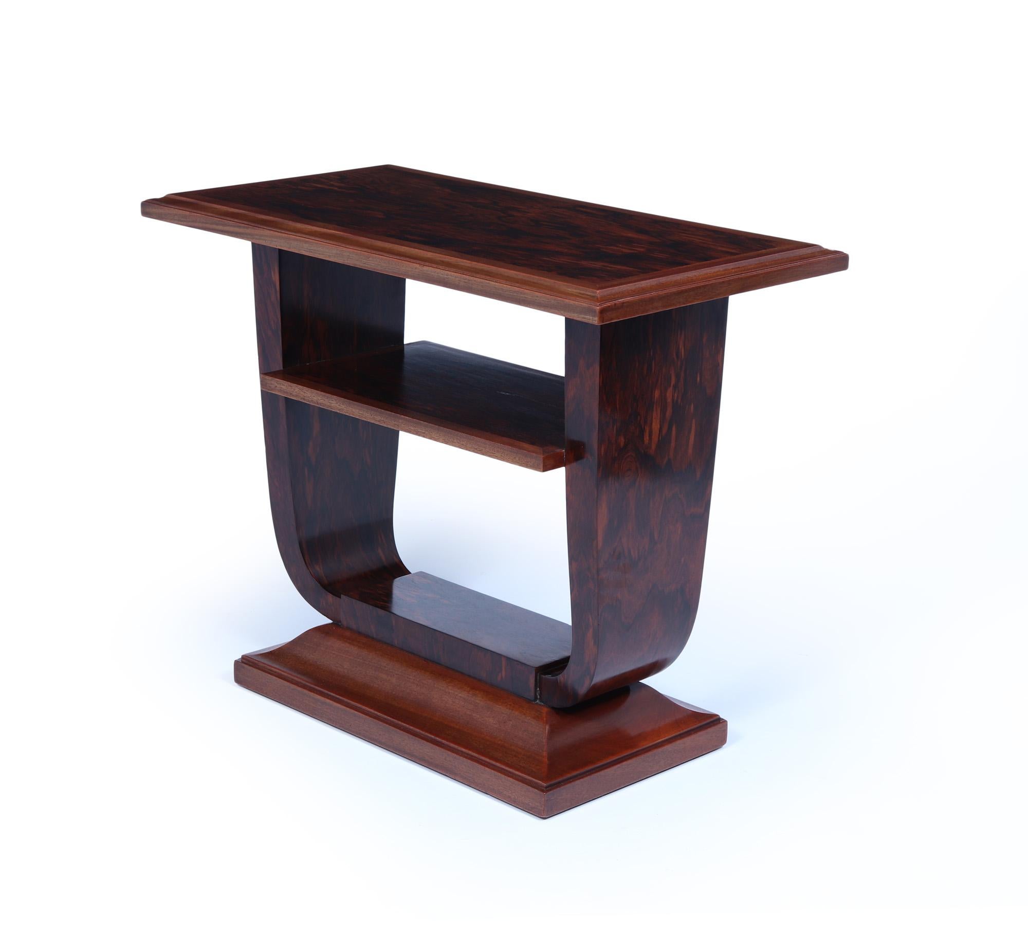 French Art Deco U Base Table in Corramandel
A French Art Deco free standing occasional table produced in France in the 1920’s in Mahogany and Corromandel having a solid shaped base with a lower shelf and solid edging. The table has been carefully