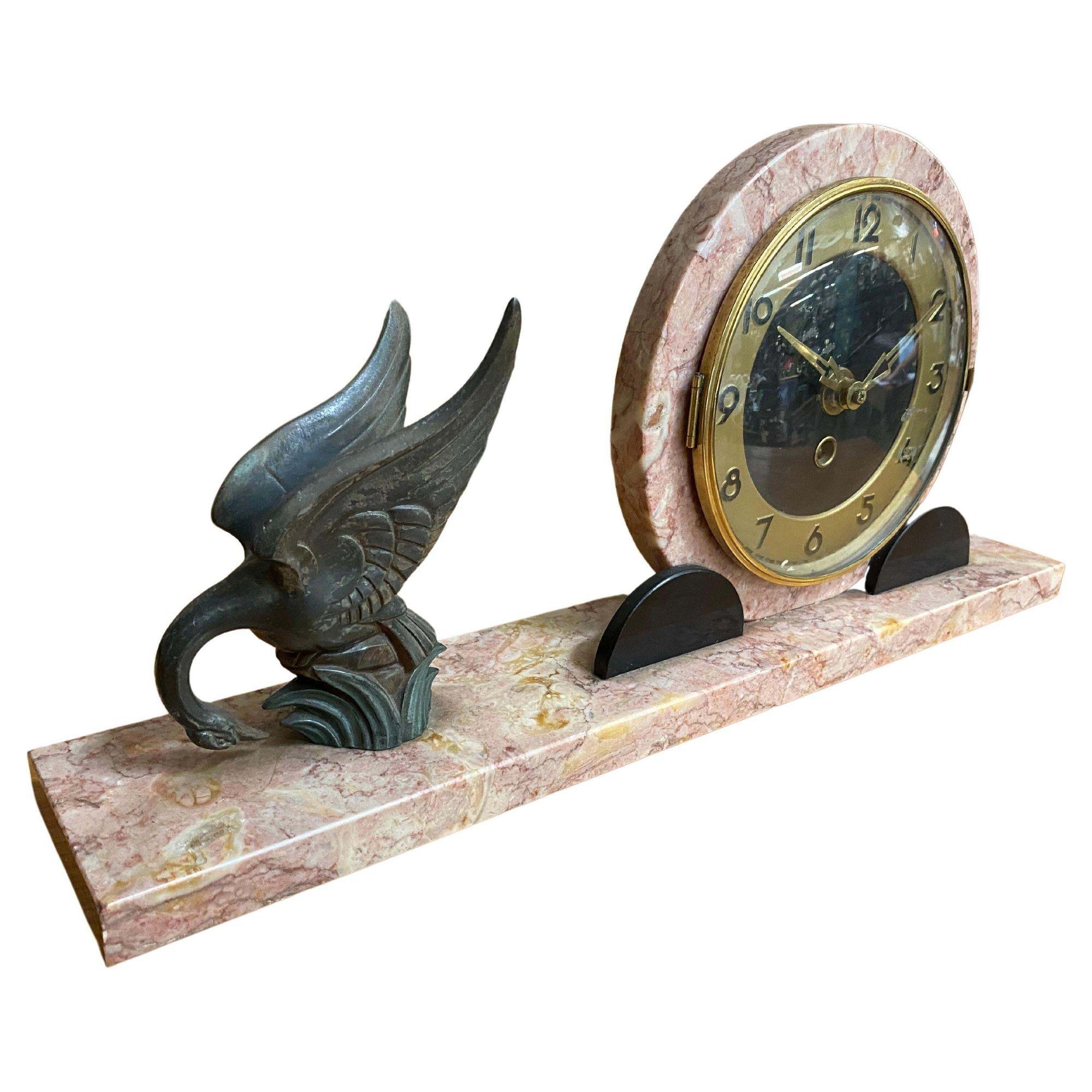 A Three Piece Marefbay Art Deco Marble and Bronze Clock Garniture, circa 1930
Marks: MAREFBAY
9 x 13-1/4 x 3 inches (22.9 x 33.7 x 7.6 cm) (clock)

The circular Arabic numeral clock on a rectangular marble base with bronze sparrows on a tree