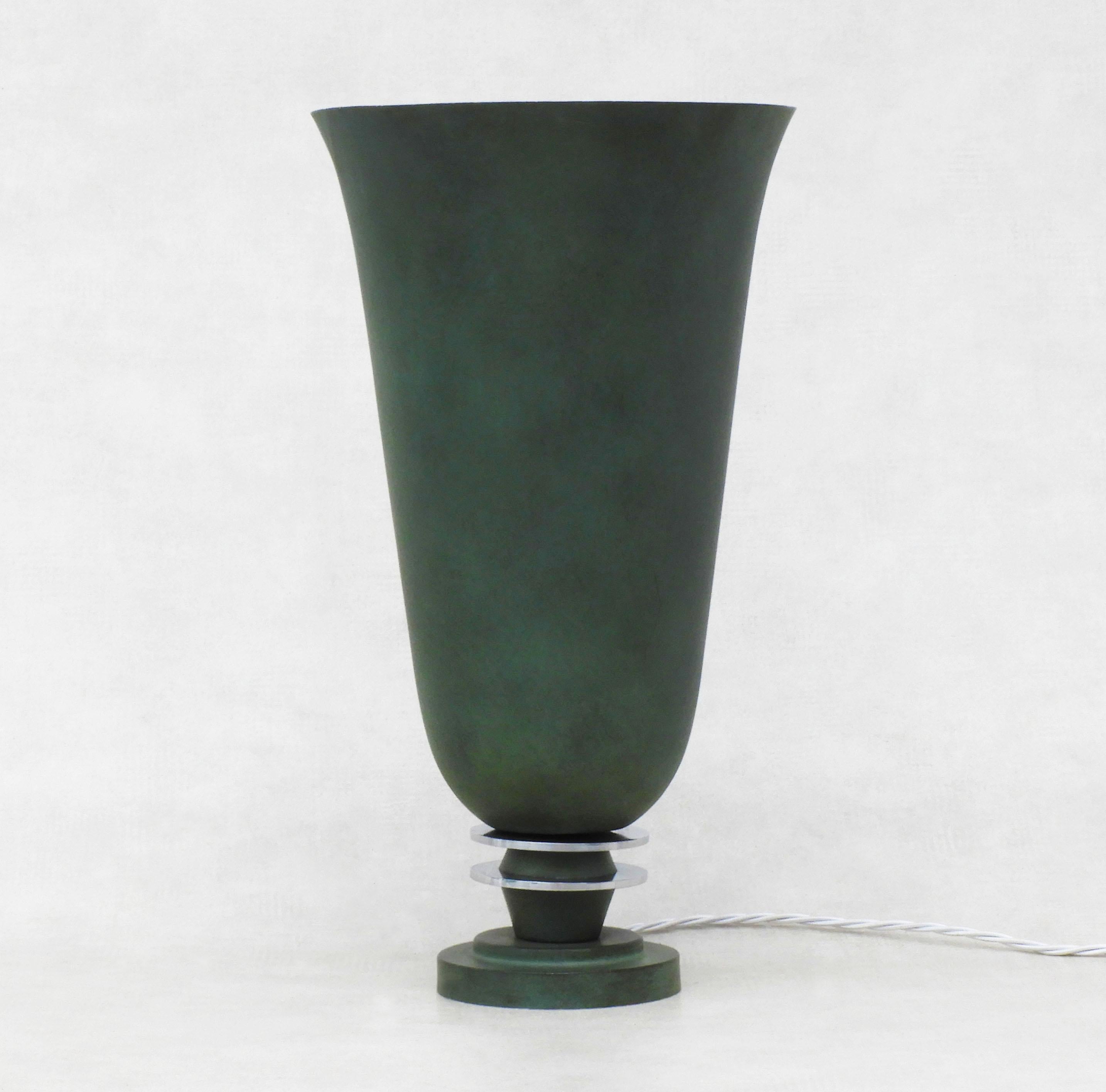 Art Deco uplighter urn lamp from 1930s France.

Striking dark green bell-shaped tabletop lamp with chrome ring detailing, which gives off an attractive, glare-free, indirect light.

In good vintage condition, some grazing to the painted