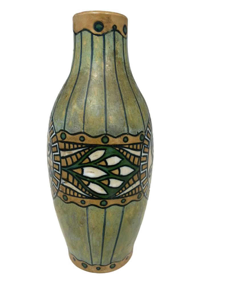 French Art Deco vase by Charles Catteau, 1920

A French Art Deco vase by Charles Catteau (1880-1966) for Grès Keramis-Boch Frères. A sandstone egg-shaped vase with open neck with model number D635 and shape number 897. A green and yellow glazed