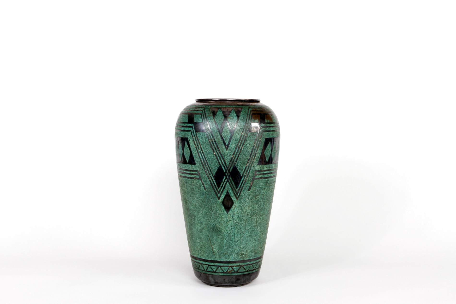French original Art Deco vase by Christofle in brass dinanderie. The model is interesting by its green color and height. Signed at  bottom. 