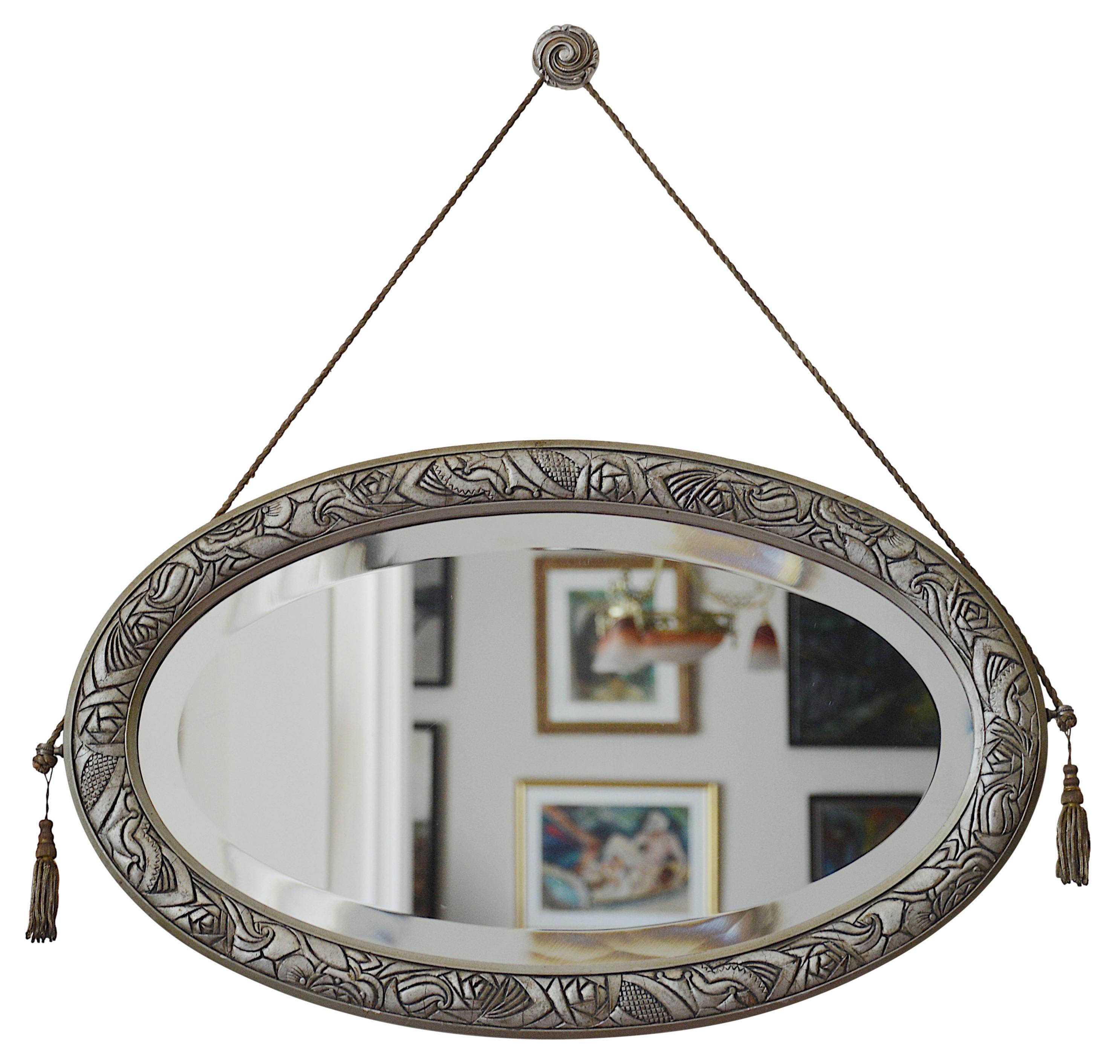 French Art Deco wall mirror, France, ca.1925. Wood, glass and bronze. Wooden frame with a stylized Art Deco pattern. 
Original beveled mirror. Solid bronze hidden-screw. Shows traces of age, this mirror is about 100 years old (see photos). Width:
