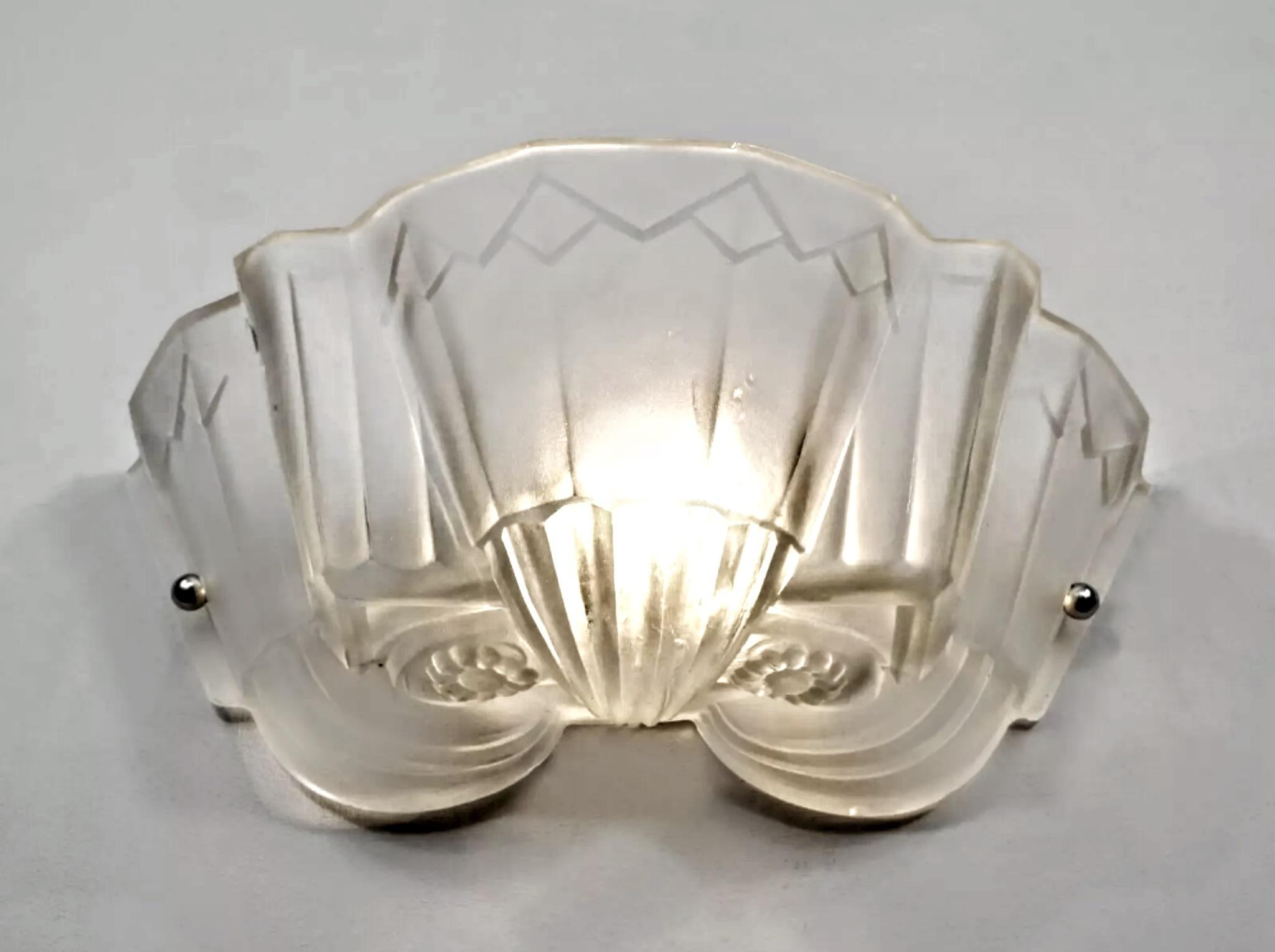 A pair of French Art Deco wall sconces was created by the French artist 