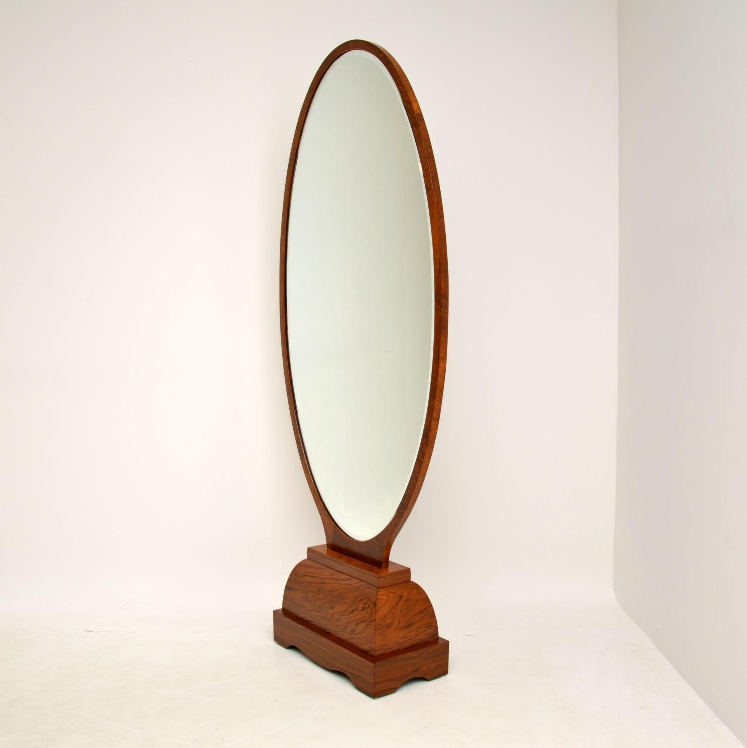 A magnificent and very large original Art Deco period free standing mirror in walnut. This was made in France, it dates from the 1920-30’s.

A rare and very impressive piece, this is extremely well made and of very high quality. The bevelled glass