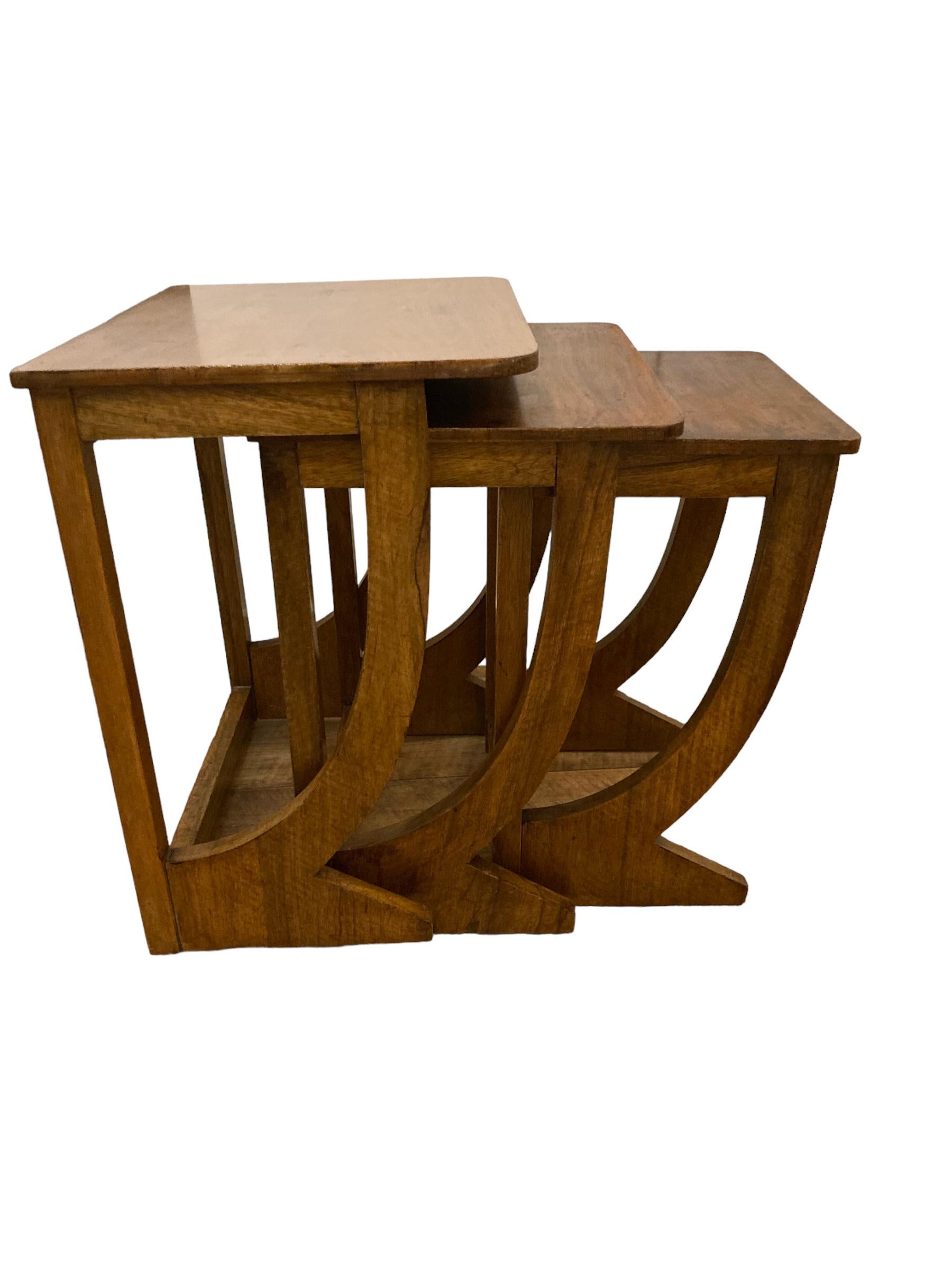 Rare Find. French Art Deco Walnut Nest of Tables. Early 1900's. Crafted with precision and attention to detail. Made from Walnut, they boast durability and longevity, ensuring years of use. Whether used together or separately, this set offers