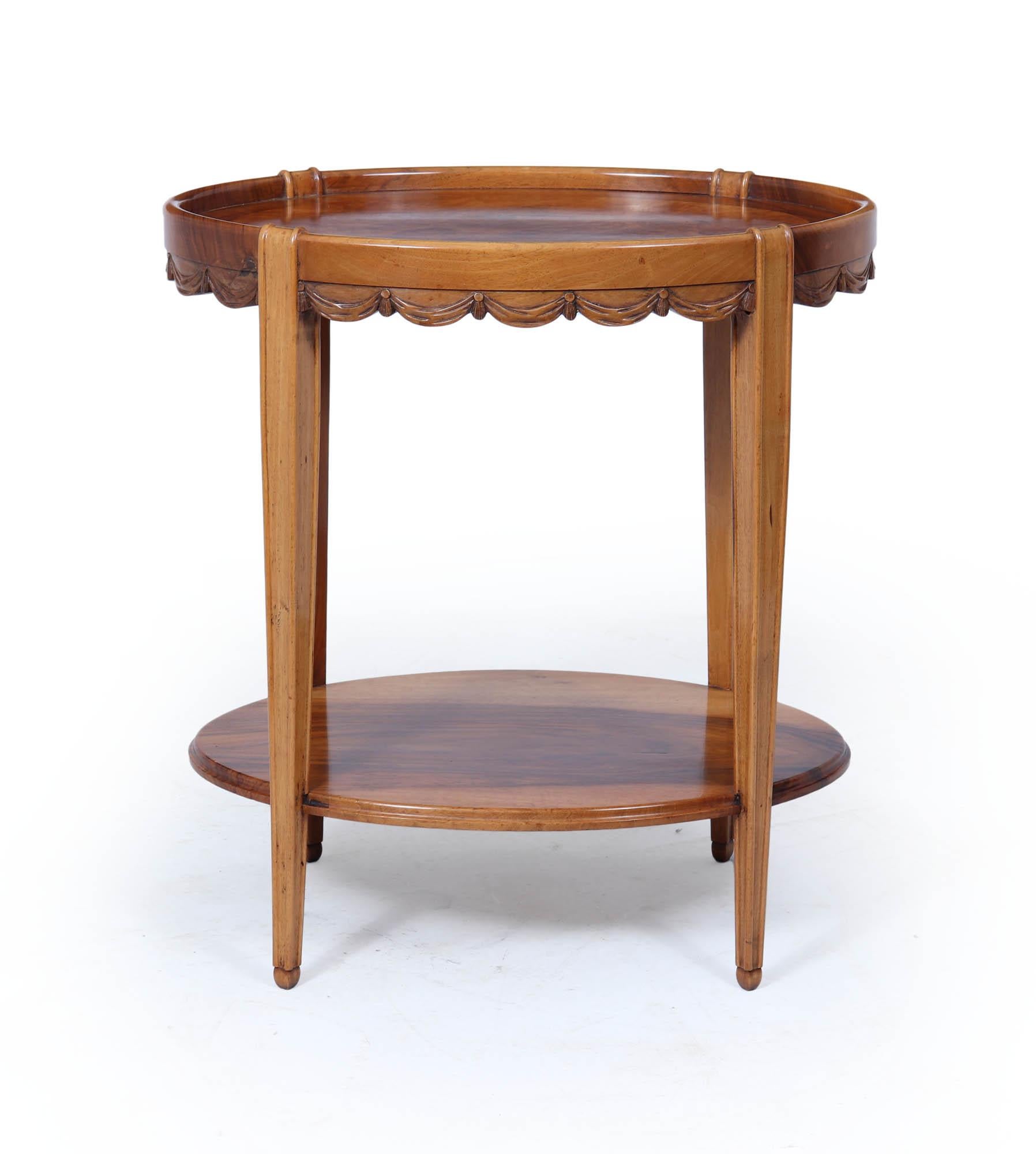 A refined and elegant French Art Deco side table in the manner of Sue et Mare, crafted in solid walnut with burr walnut bookmatched walnut veneer, circa 1925. This beautifully proportioned piece blends neoclassical grace with the decorative flair of