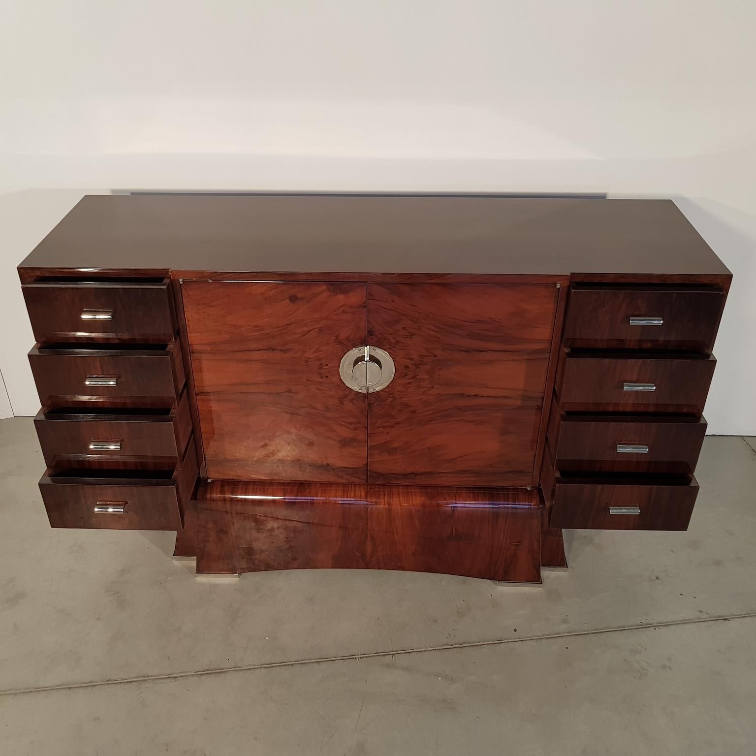 Nice Art Deco sideboard with special leg, lacquered walnut veneer and nickel-plated handles, France, 1930s. Recently restored.