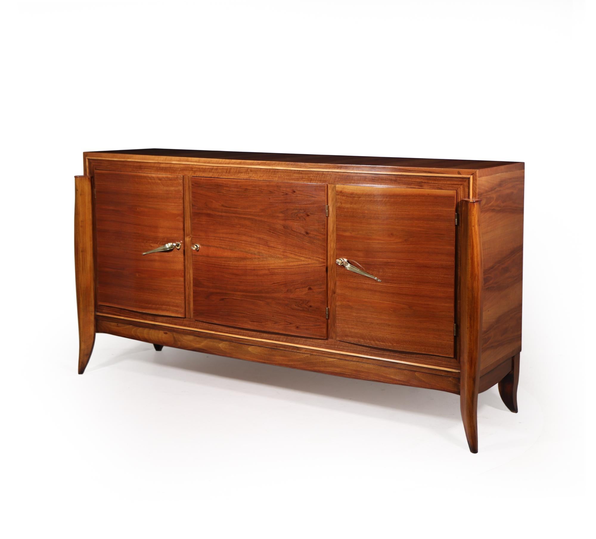A French three door sideboard in walnut with sabre legs the sideboard has brass handles and three keys, on the inside the sideboard has one long shelf and two drawers, the sideboard has been restored where necessary and full polished by hand and is