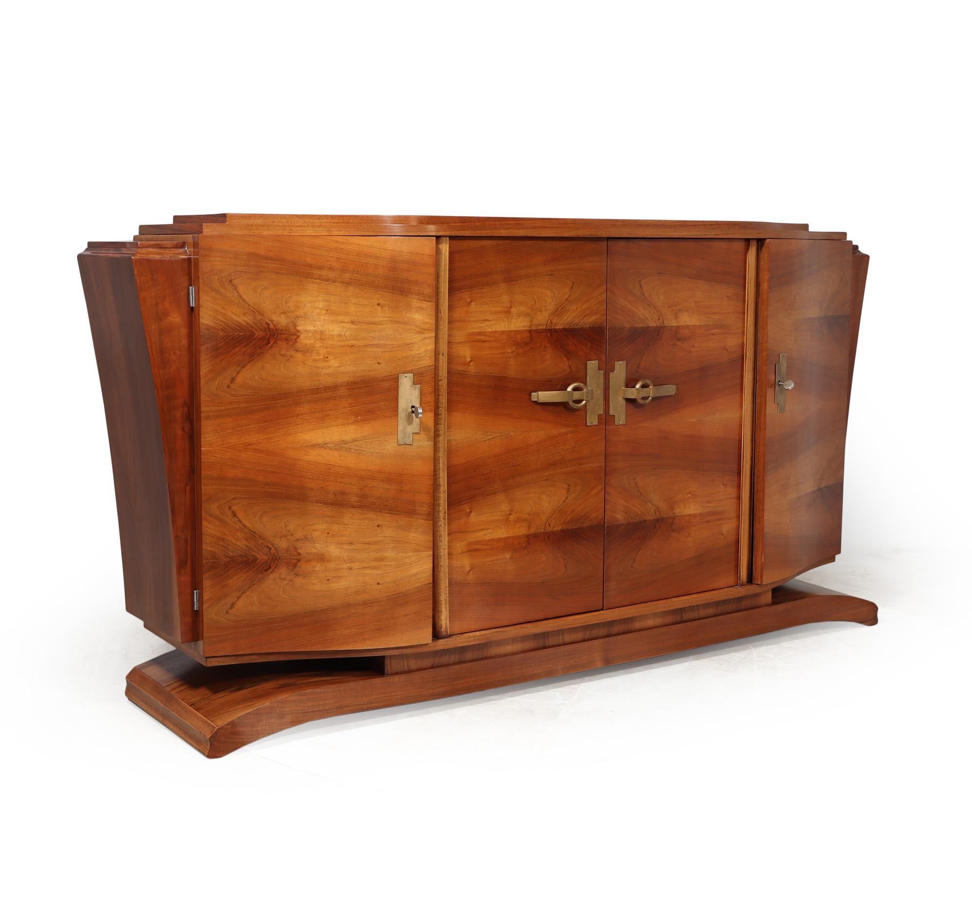FRENCH ART DECO WALNUT SIDEBOARD
This French art deco walnut sideboard, crafted in the glamorous era of the 1930s, boasts a sophisticated stylish design. The four doors feature adjustable shelves concealed behind opulent gold patinated handles,
