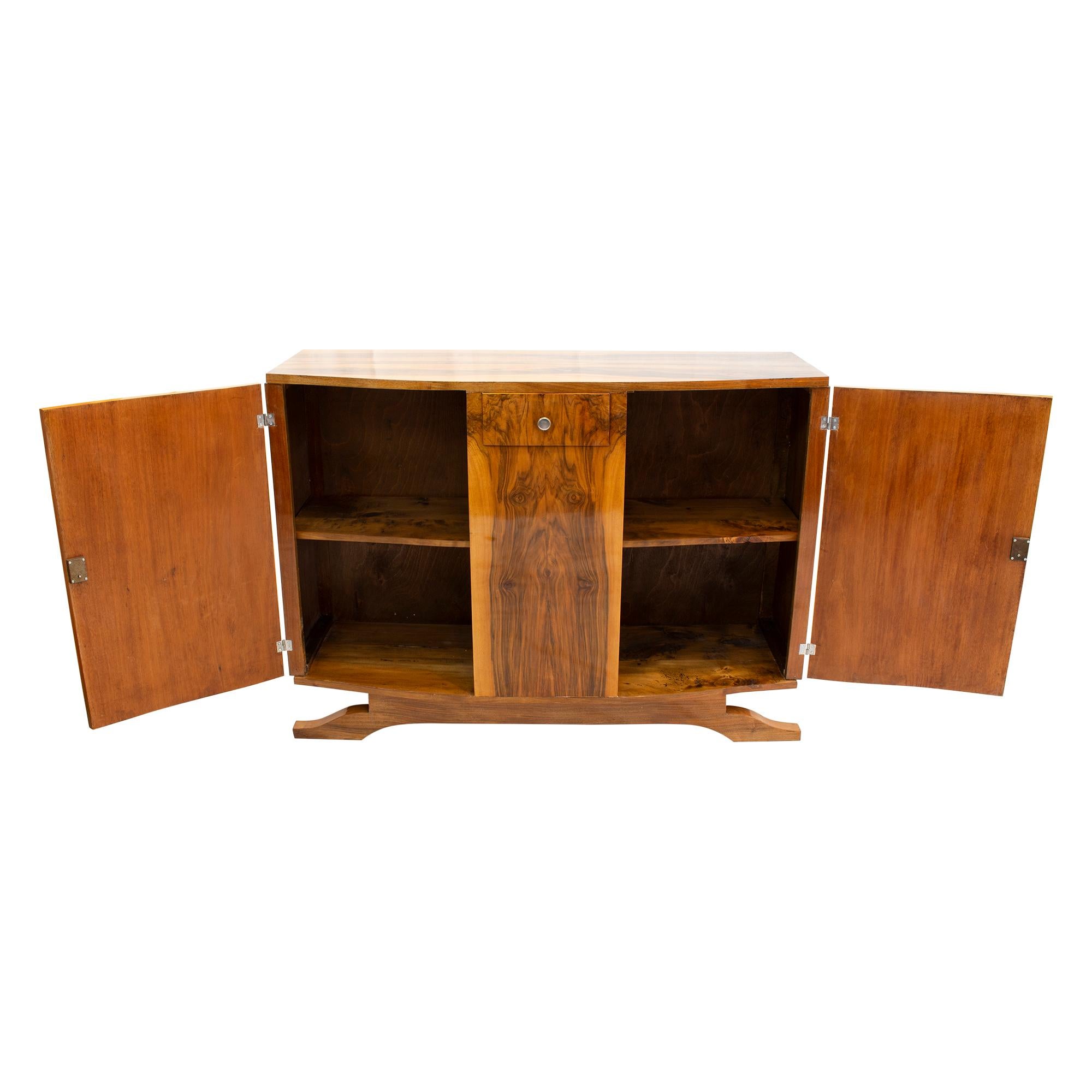 Beautiful sideboard. The sideboard was made of walnut veneer on softwood carcass. It comes from France from the Art Deco period around 1930. The fittings and the locks are original. The sideboard was hand polished. The veneer pattern is continuous,